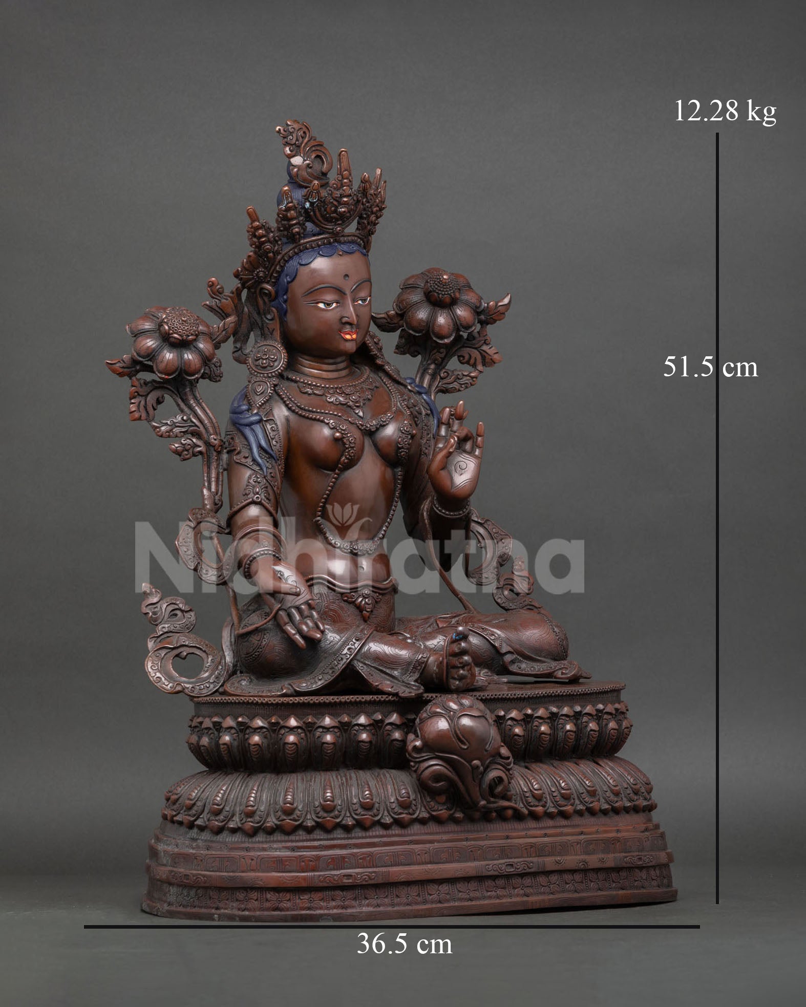 Green Tara statue, extended leg resting on lotus flower, compassionate deity, oxidized copper sculpture