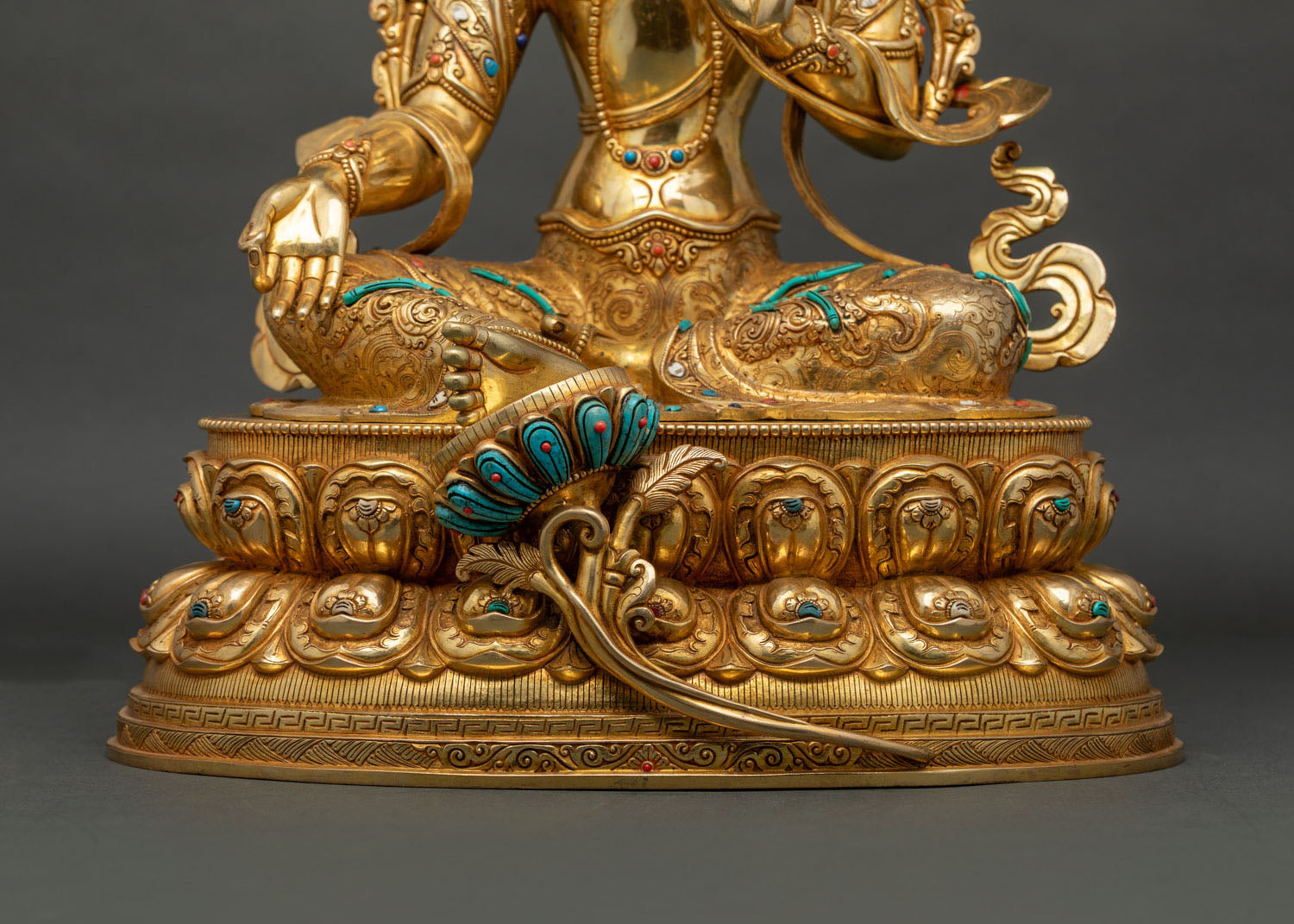 Green Tara statue, featuring repoussé detailing and hand chased floral engravings by Newari artisans.