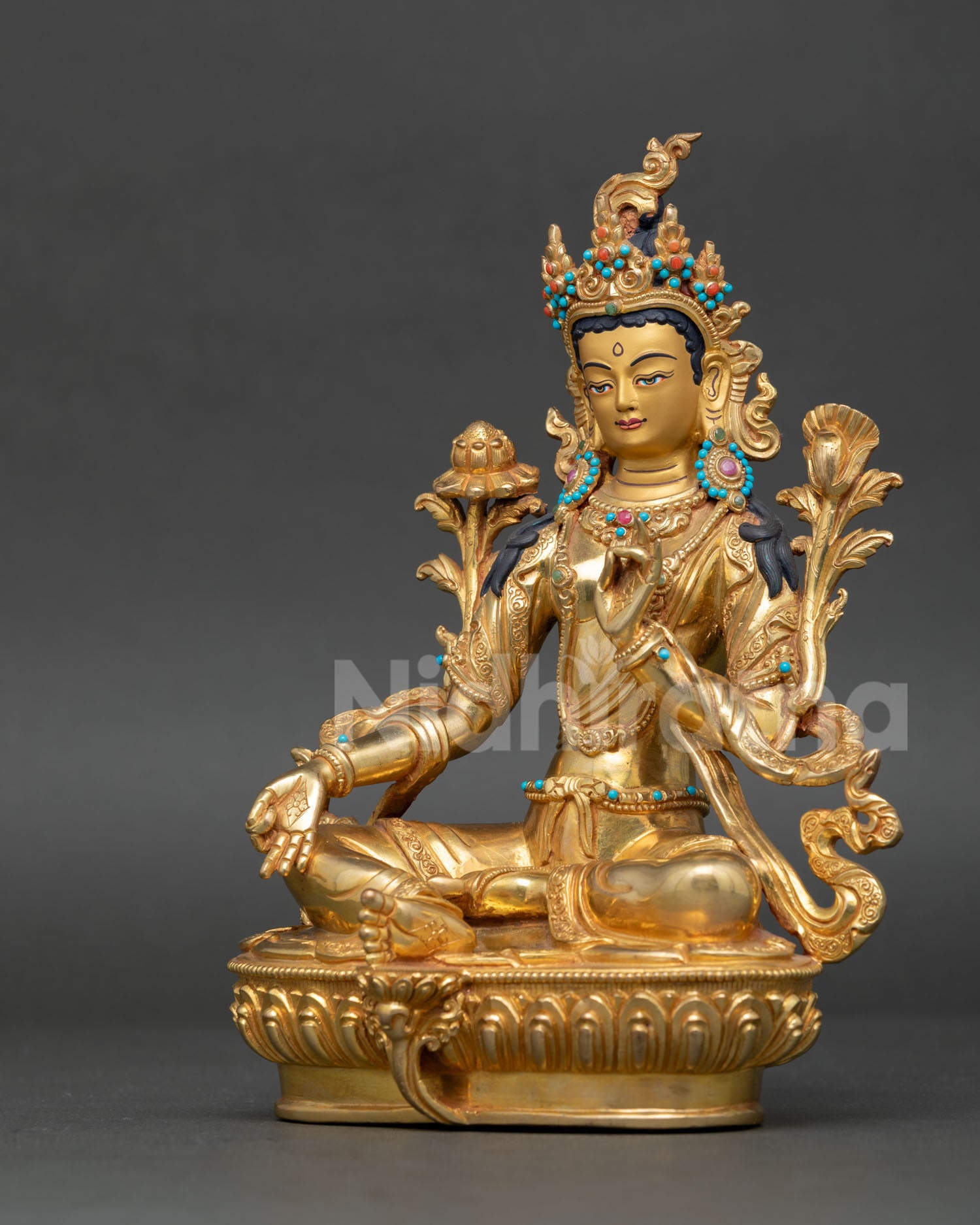 Green Tara statue handcrafted by Newari artisan from Patan Nepal with gold gilded copper finish and 24k gold painted face.