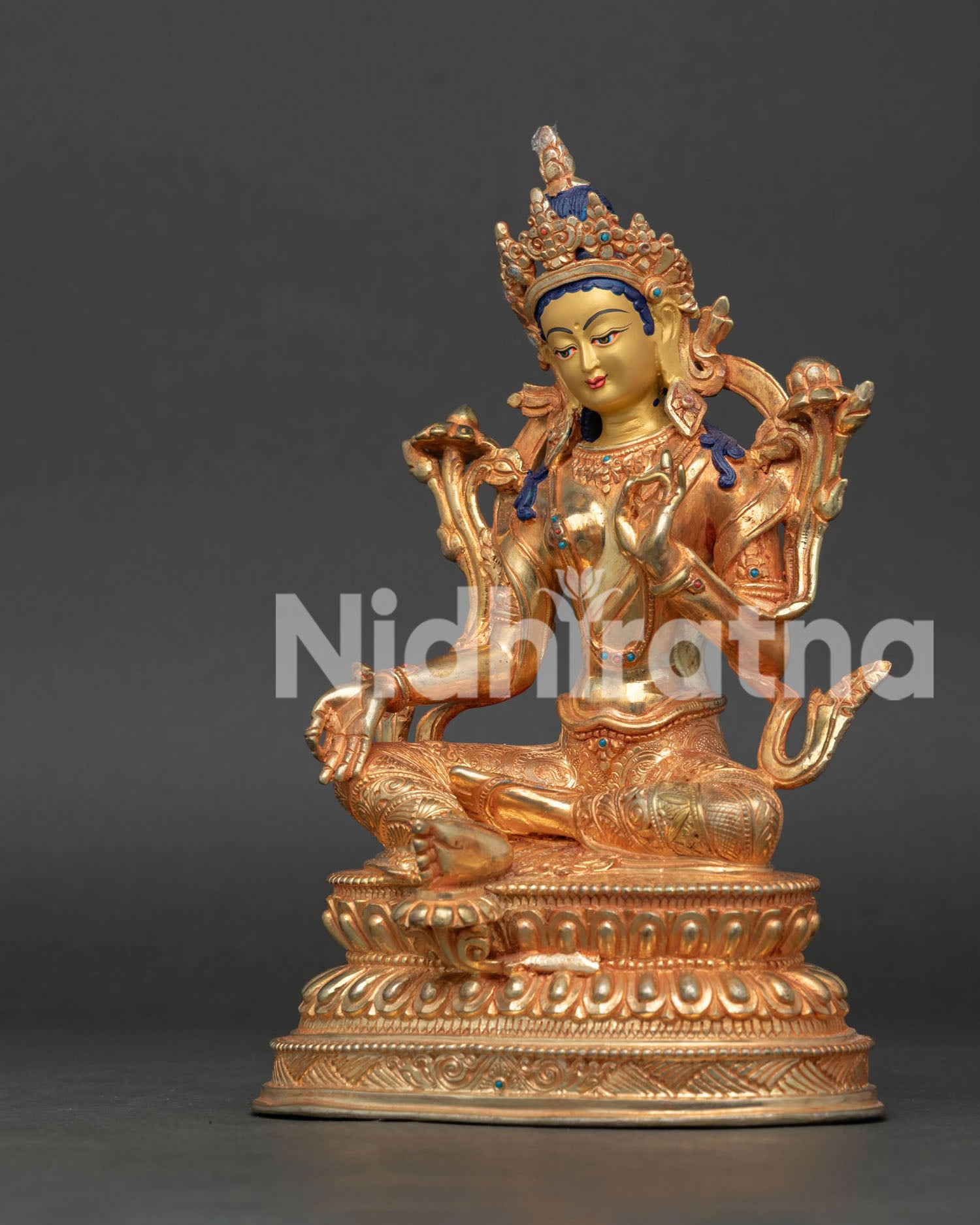 Green Tara statue handcrafted in Nepal with gold gilding, 24K gold face, turquoise and coral stones.