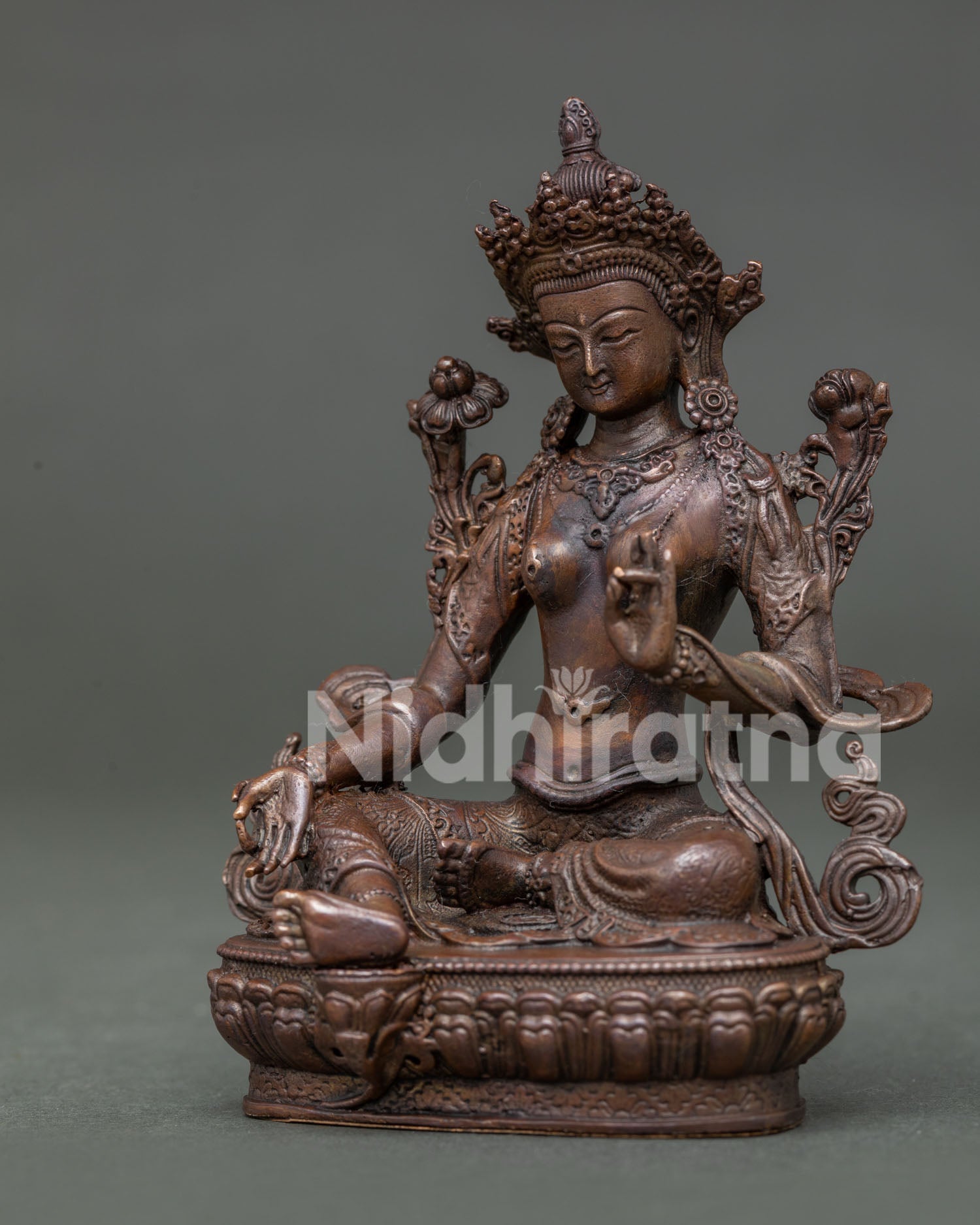 Green Tara Statue handcrafted in Patan Nepal with oxidized copper finish and lotus pedestal.