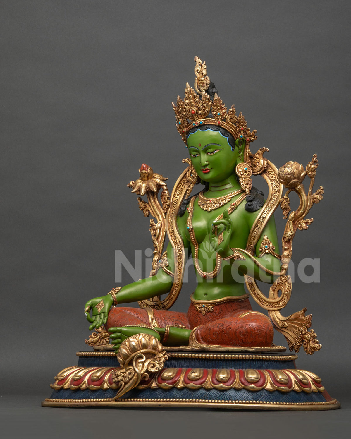 Green Tara statue left side view showing Vitarka Mudra and Utpala lotus, copper Buddhist art