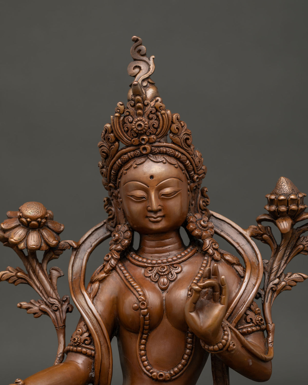 Green Tara Statue oxidized copper, close up view of crown, mudra and lotus detail
