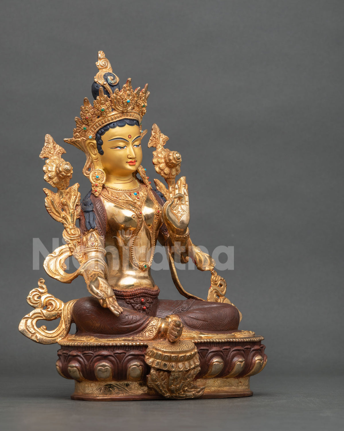 Green Tara statue right side view Lalitasana posture utpala flower.