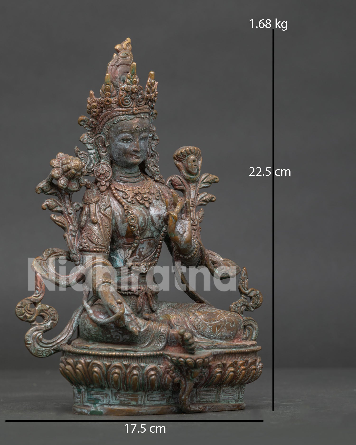 Green Tara statue seated in lalitasana posture on lotus pedestal with extended foot.