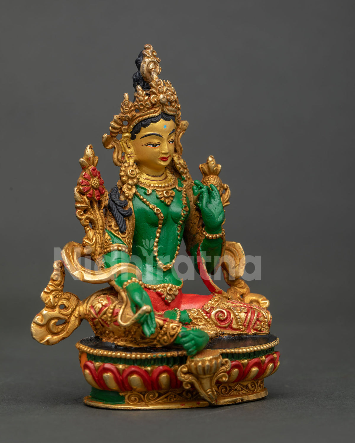Green Tara statue seated on hand carved lotus pedestal.