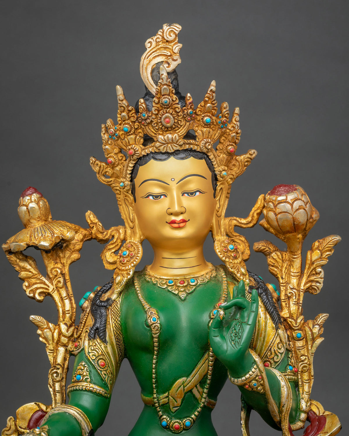 Green Tara statue adorned with semi precious stones and 24K gold painted details.