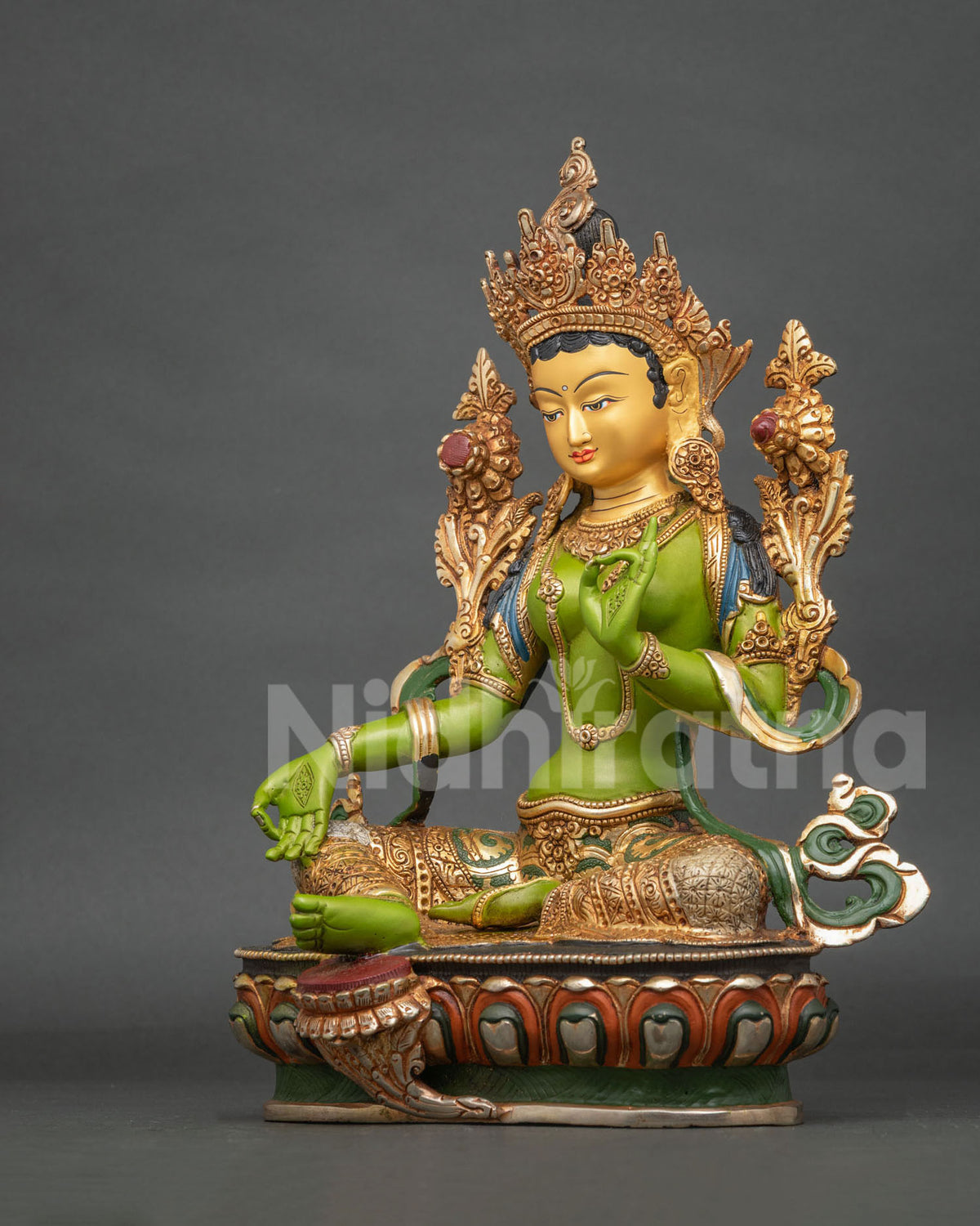 Green Tara statue adorned with semi precious stones and a 24K gold painted face.