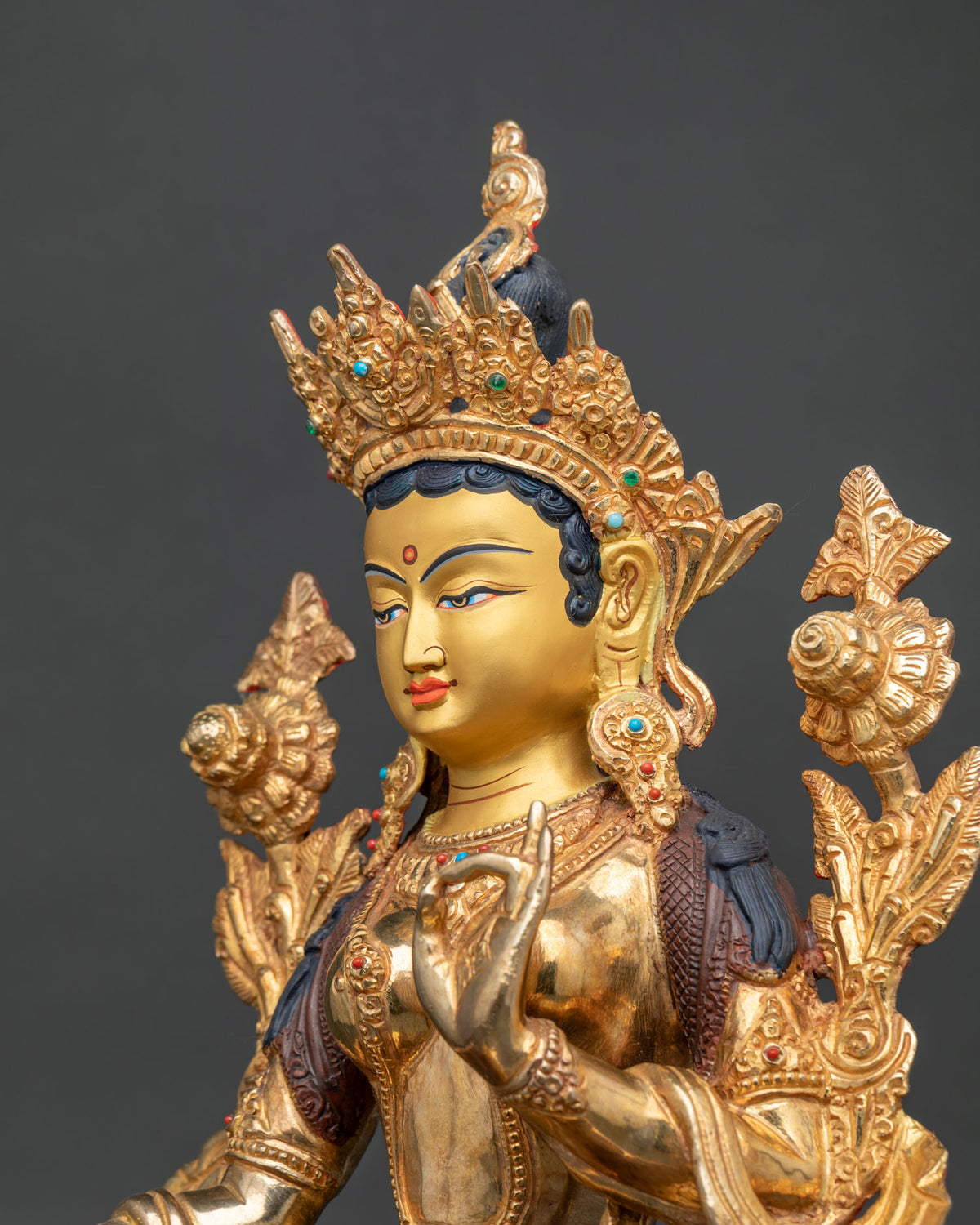 Green Tara statue side close up silk garment necklaces and jewelry.