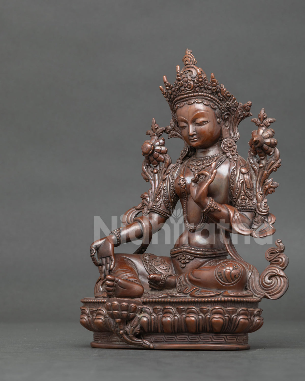 Green Tara statue varada mudra vitarka mudra with utpala lotus.