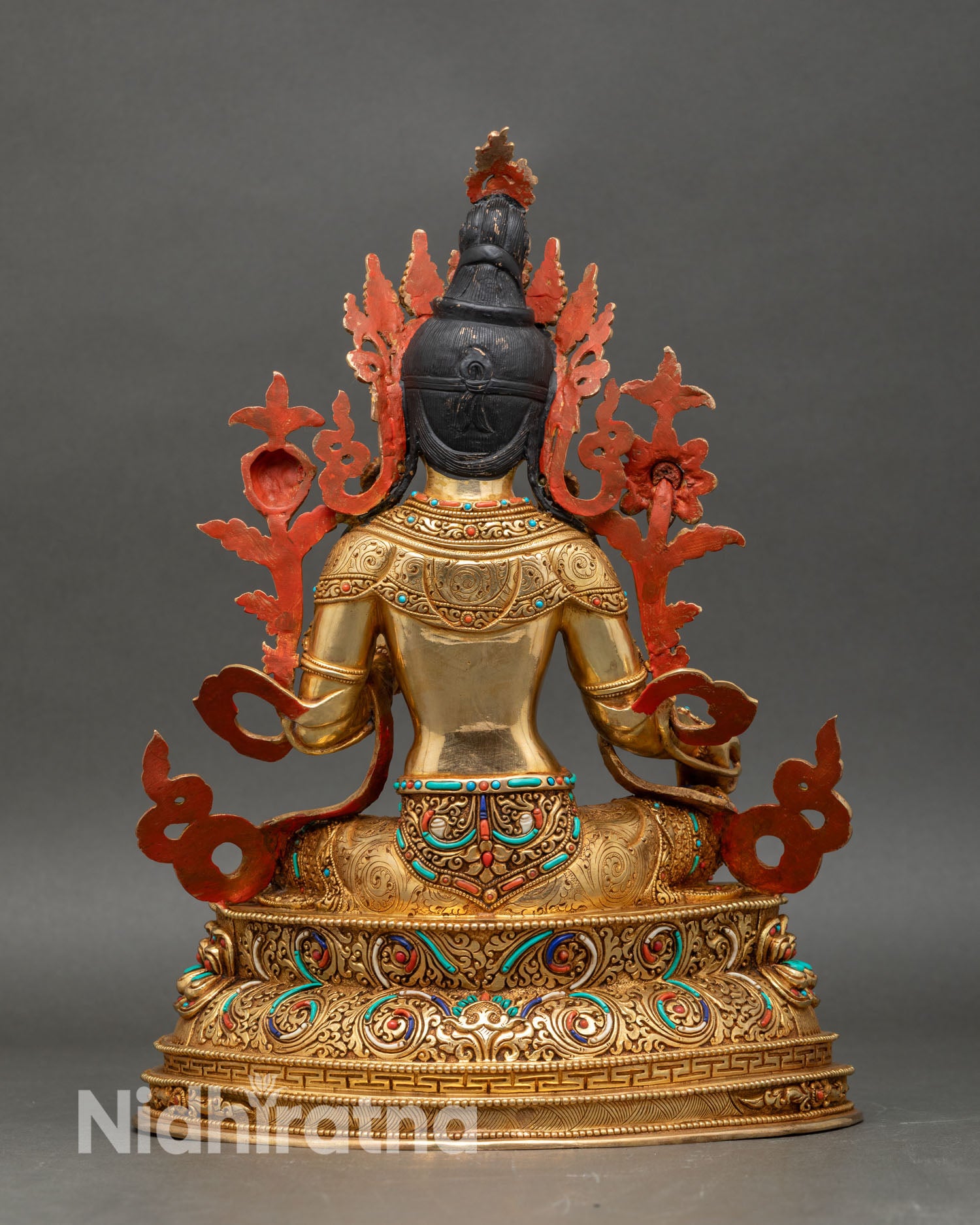Green Tara statue with utpala flower and intricately carved details