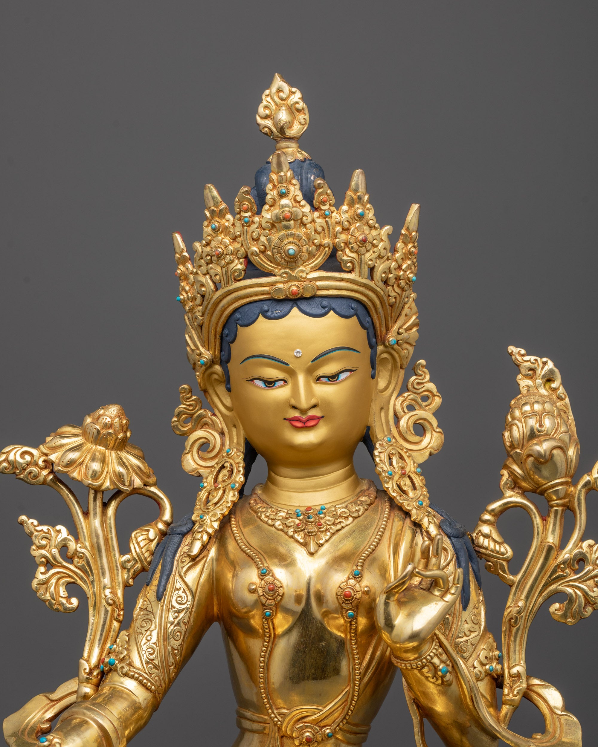 green tara statue close up showing utpala flower and five-jeweled crown with semi-precious stones