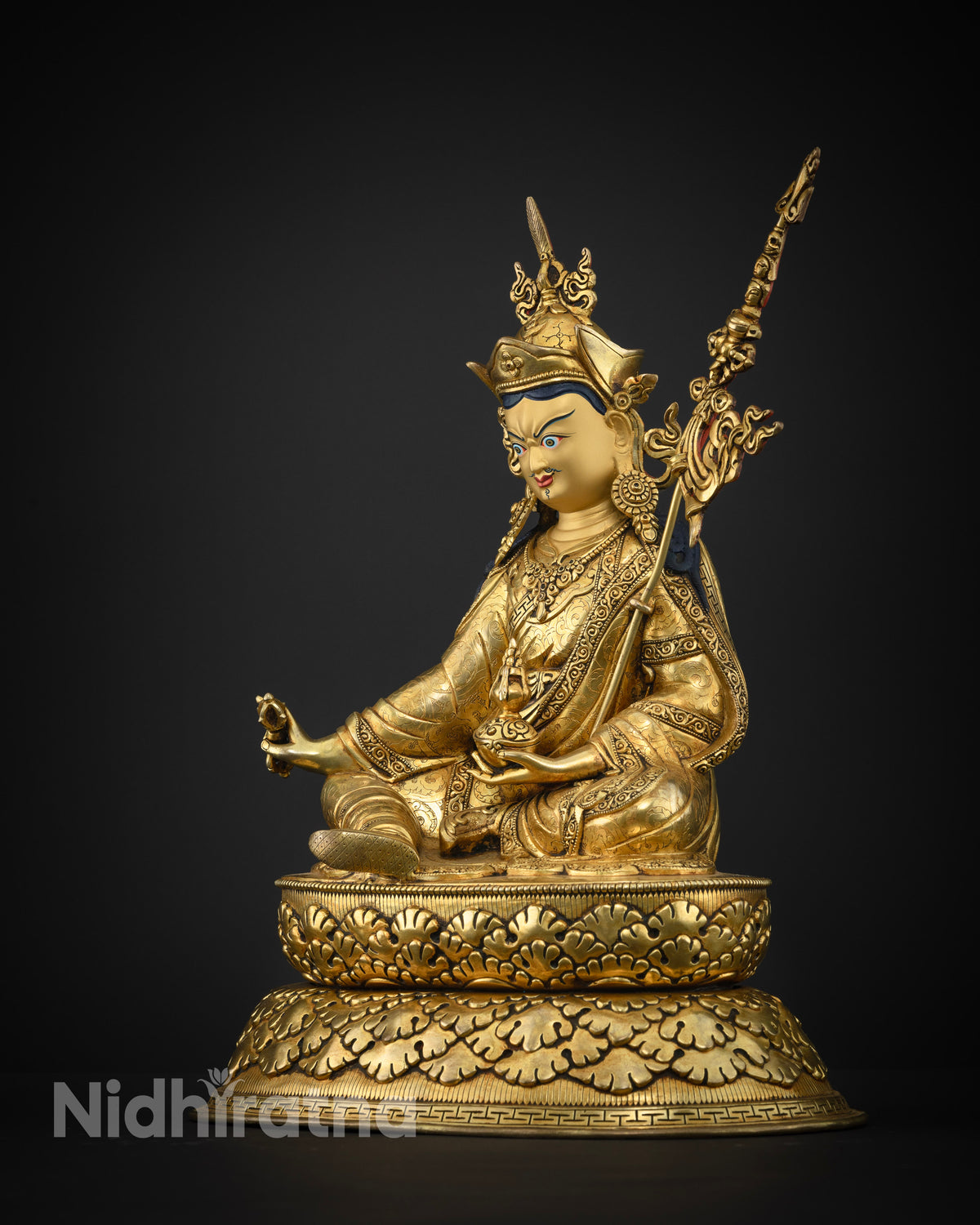Guru Padmasambhava statue lotus hat khatvanga trident left side view.
