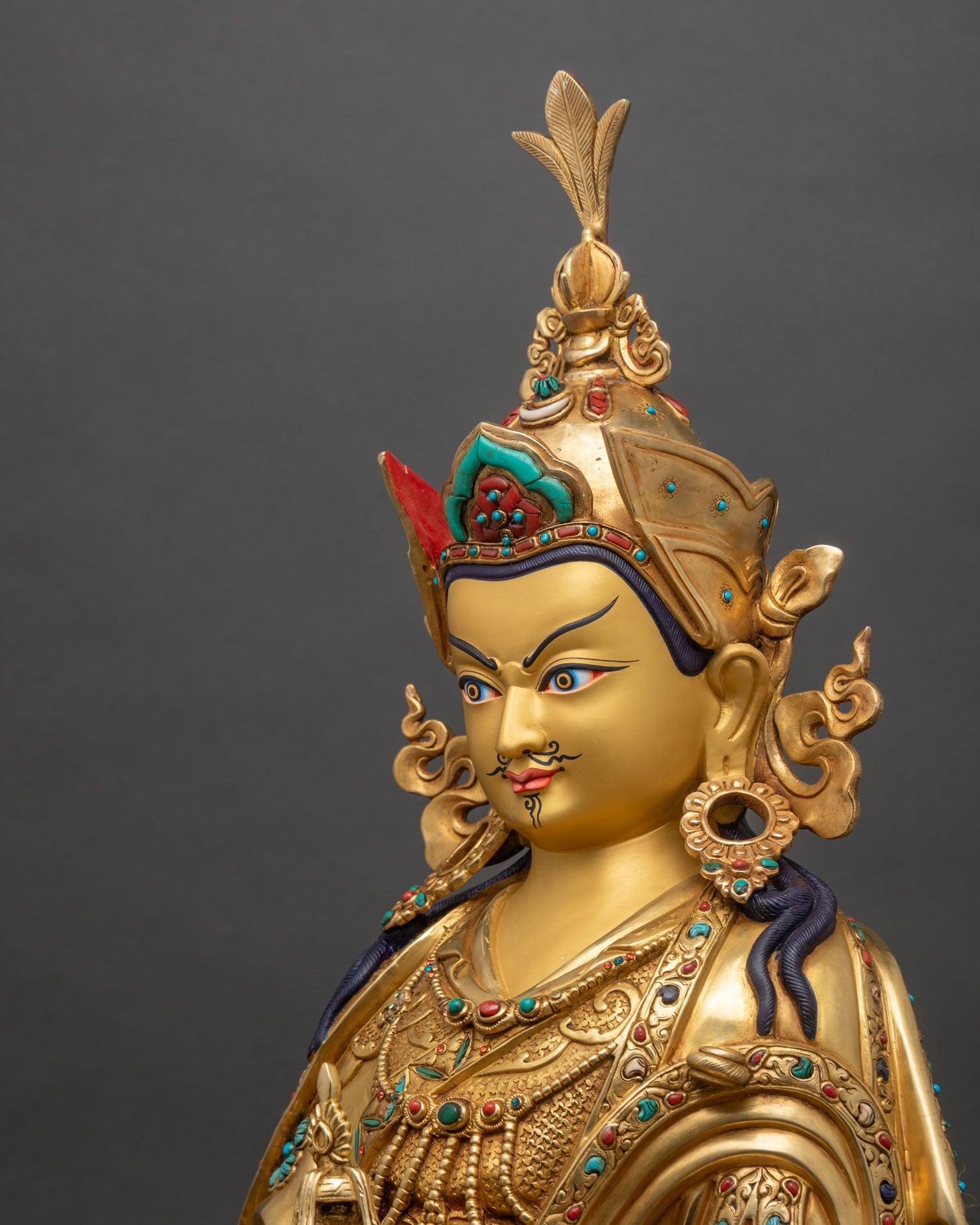 Guru Padmasambhava side view showing gold fire-gilded copper and khatvanga staff