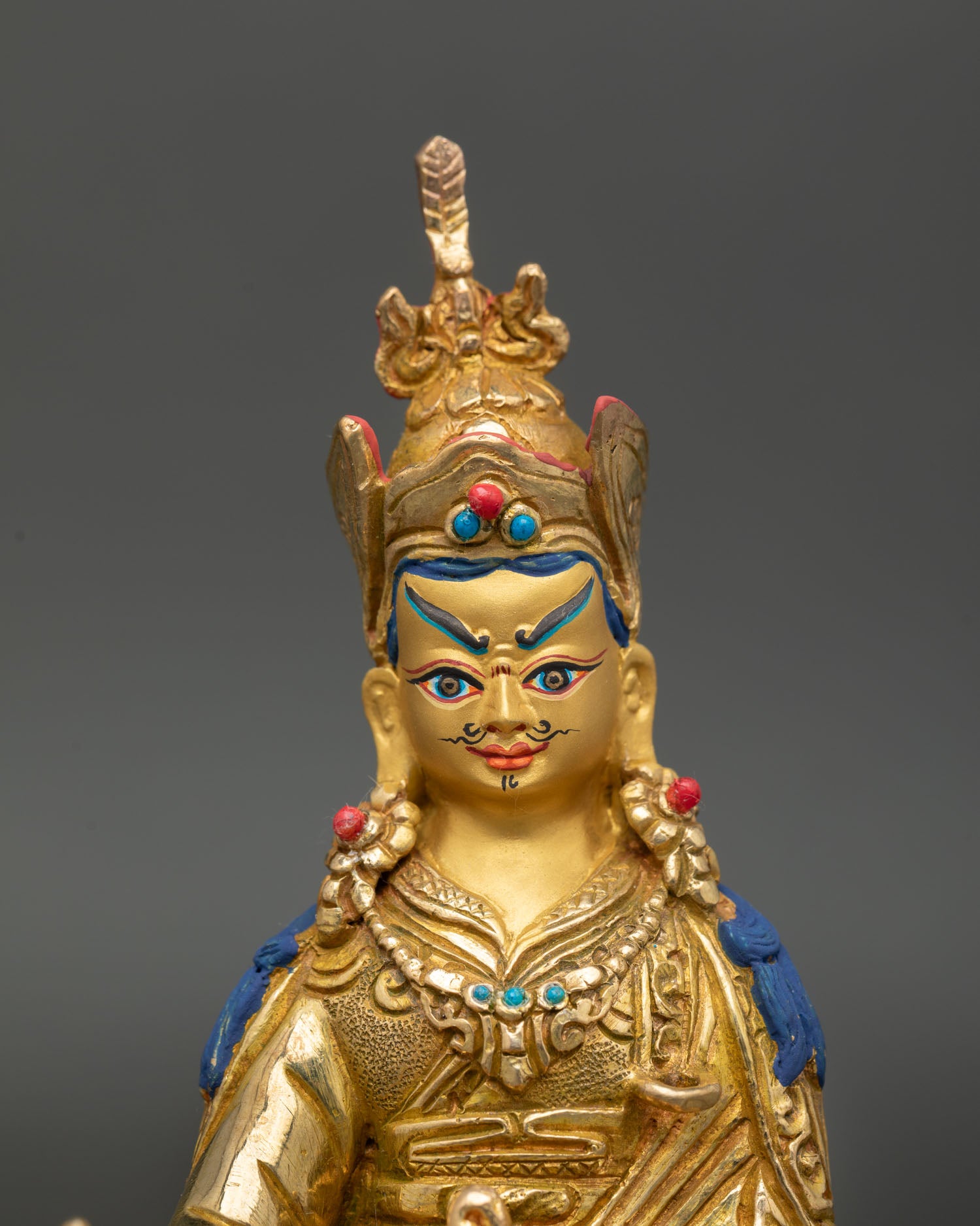 Guru Rinpoche close up gold painted face detail lost wax casting himalayan buddhist sculpture