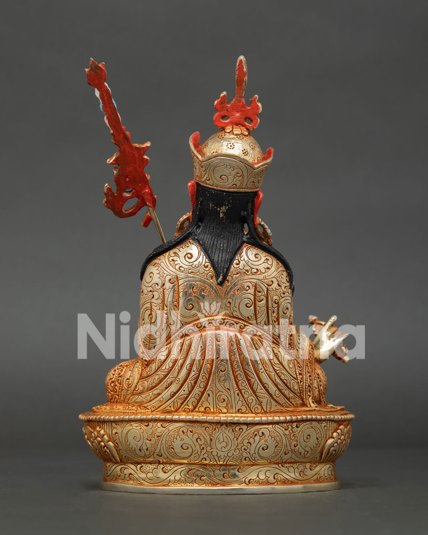 Guru Rinpoche seated on lotus throne holding vajra kapala and sacred khatvanga trident