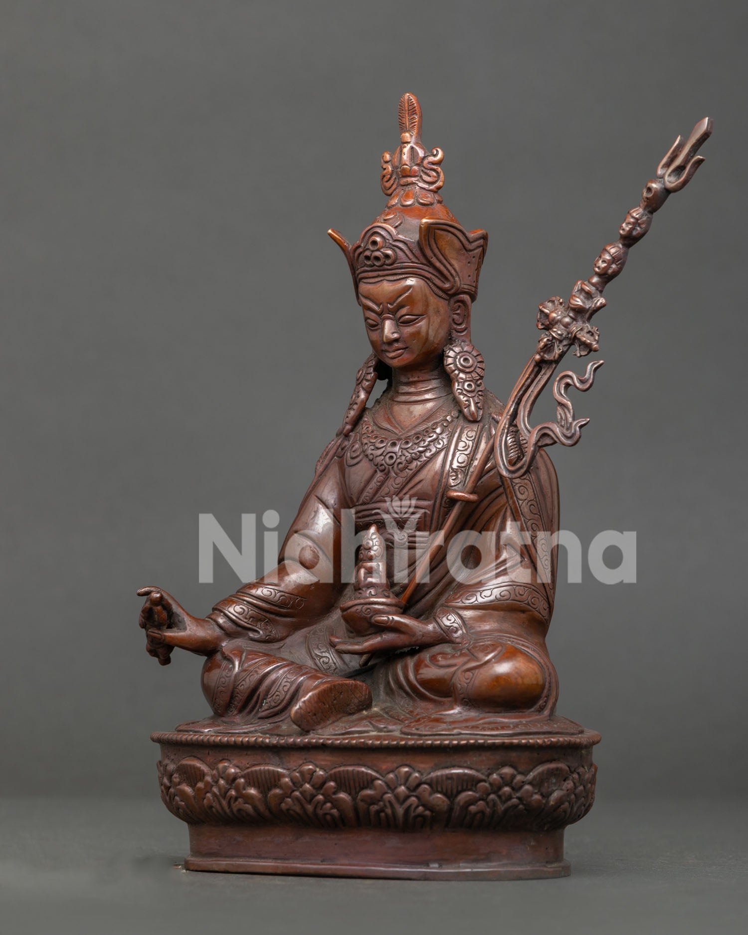 Guru Rinpoche side view showing hand carved robe and sacred ritual attributes.