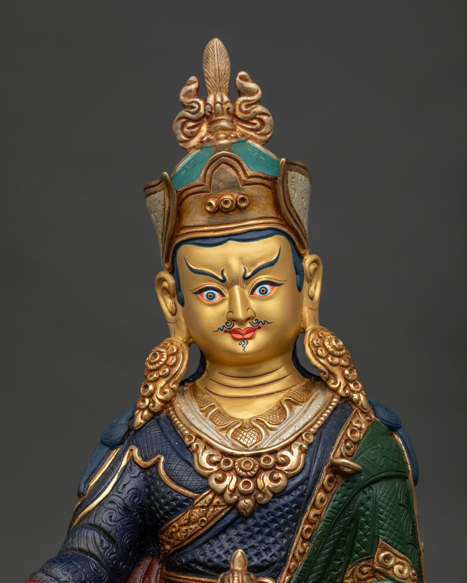 Guru Rinpoche statue close up showing copper body and intricate Buddhist details
