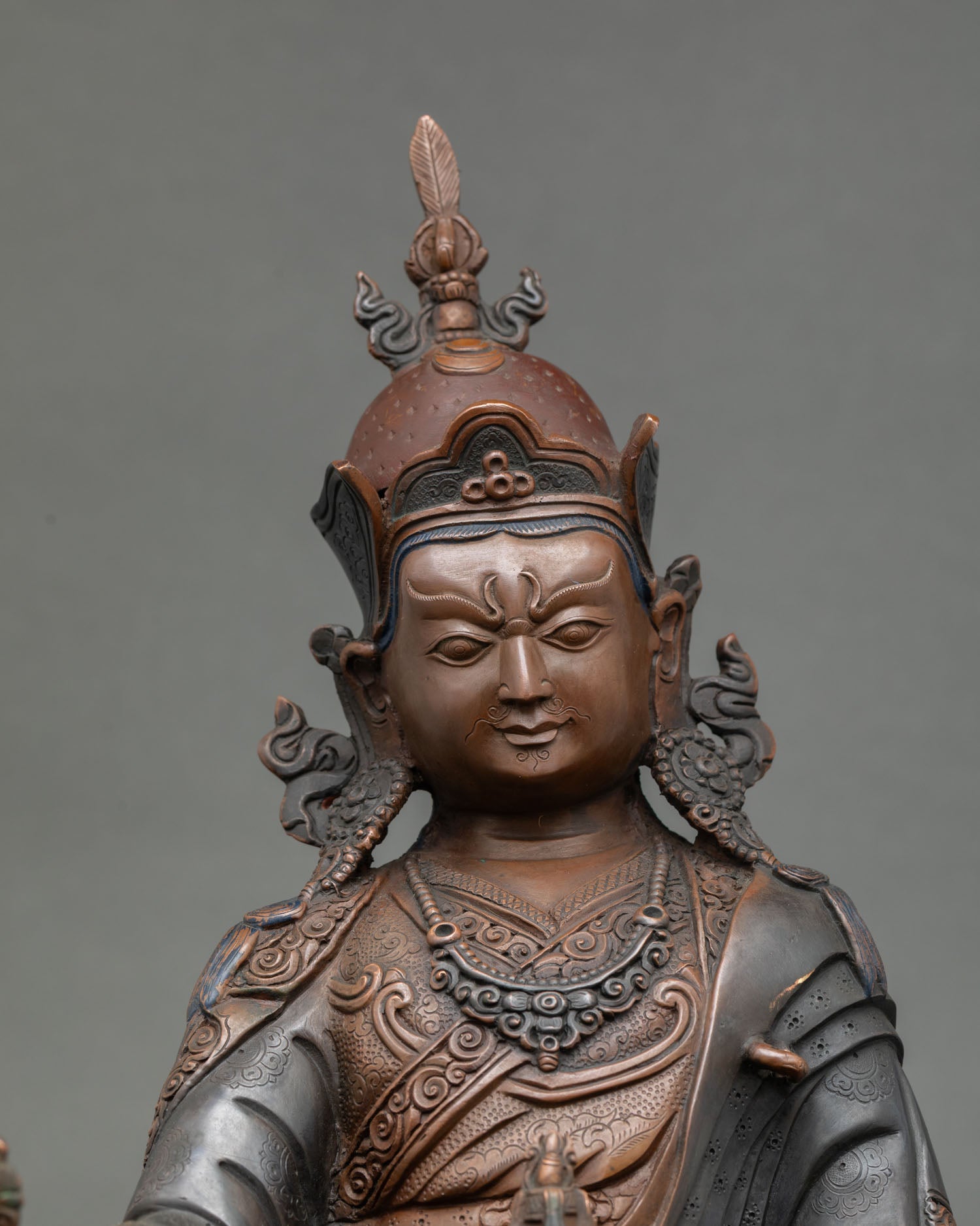 Guru Rinpoche statue close up view serene face spiritual mastery Second Buddha Himalayan art detail