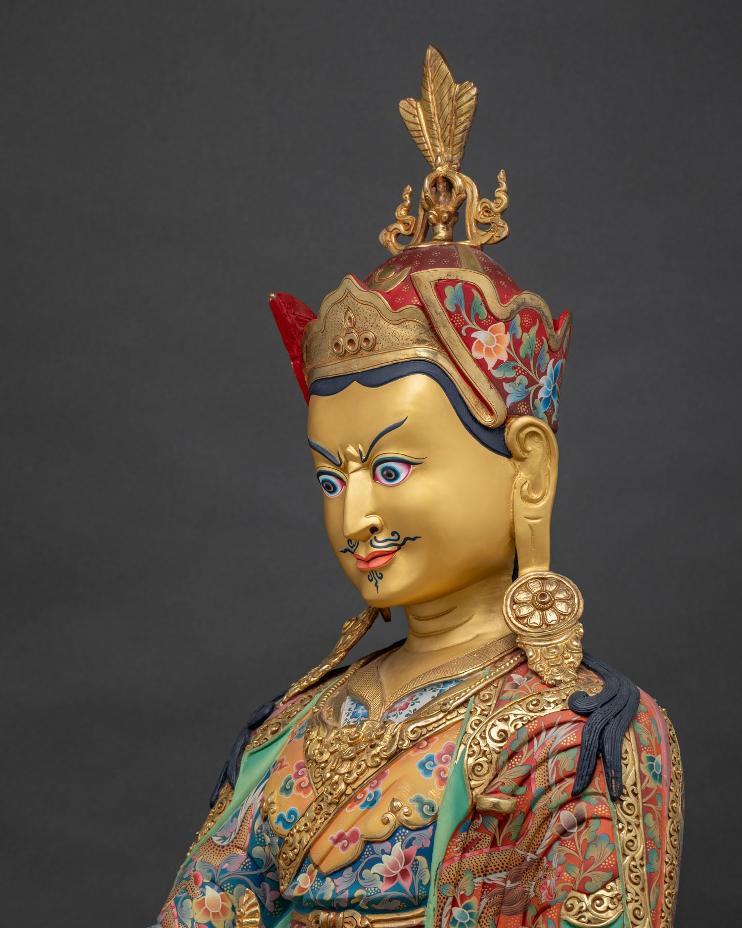 Guru Rinpoche statue detailed side close up revealing ornate robes and finely chased copperwork