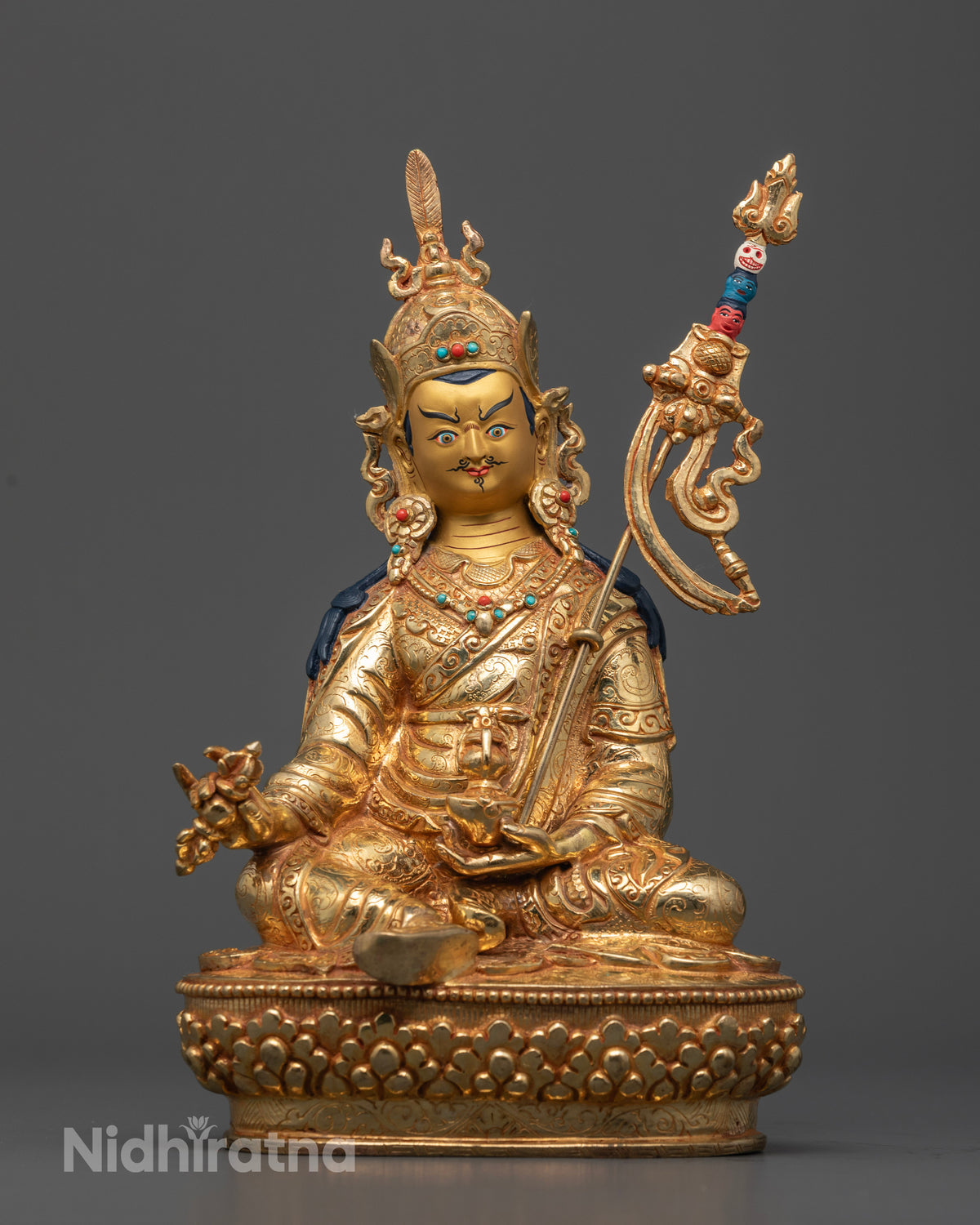 Guru Rinpoche statue with gold gilding, gold-painted face, and semi-precious stones