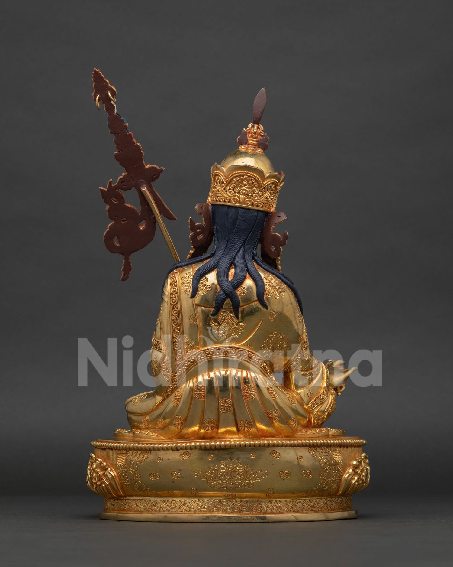 Guru Rinpoche statue showing Ashtamangala garment carving and vulture feather.