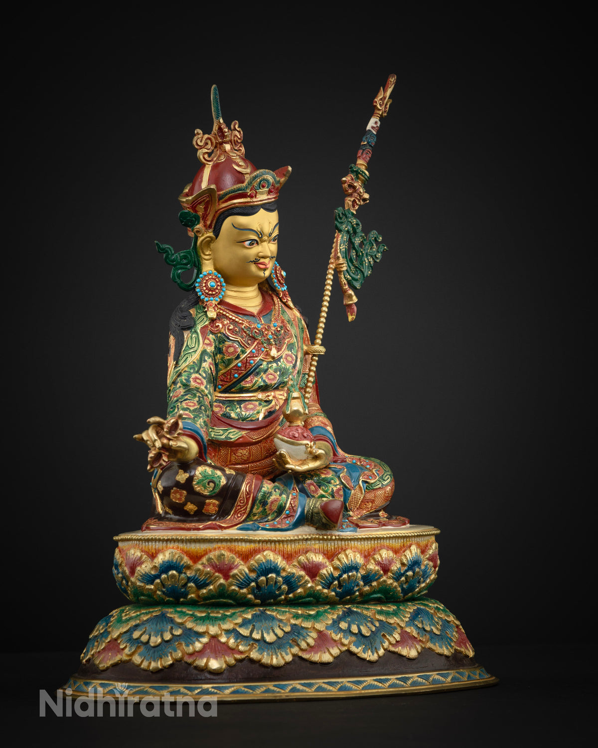 Guru Rinpoche statue side view holding vajra and kapala on double lotus pedestal, fire-gilded copper