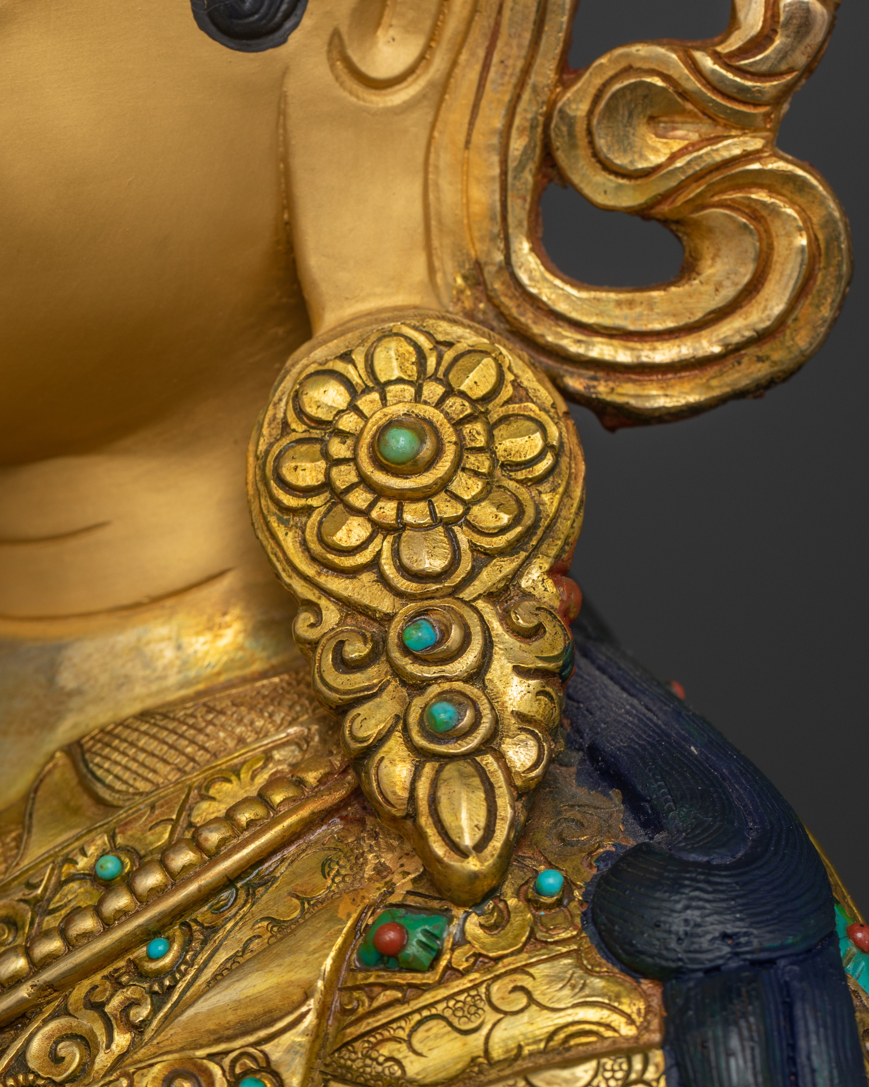 earring of guru rinpoche Padmasambhava statue adorned with turquoise gemstone
