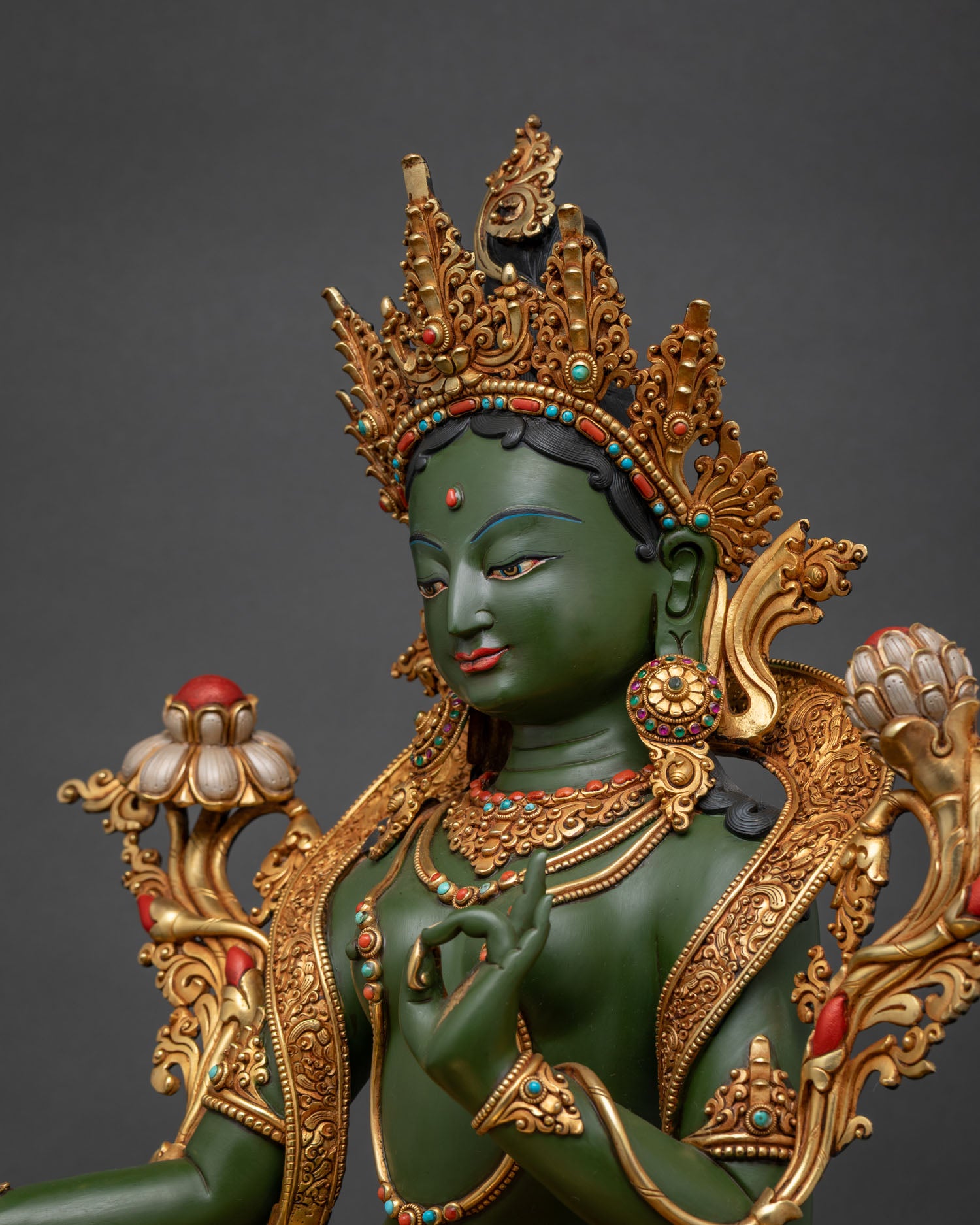 Hand-carved Green Tara statue side view showing intricate robes and semi-precious turquoise inlay details