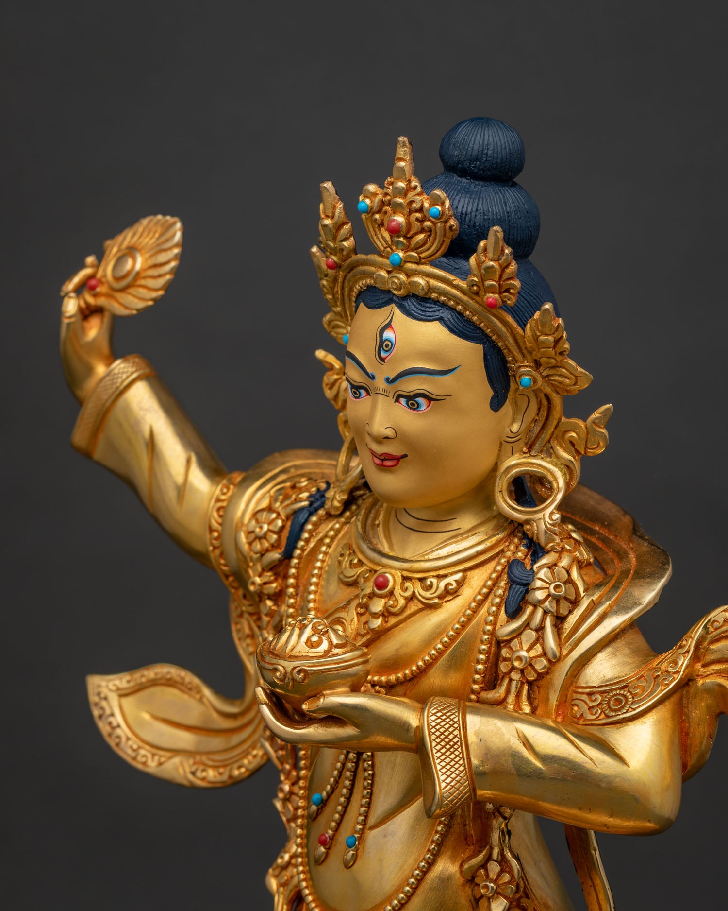 Hand-chased side detail of Achi Chokyi Drolma's ornate jewelry and robes