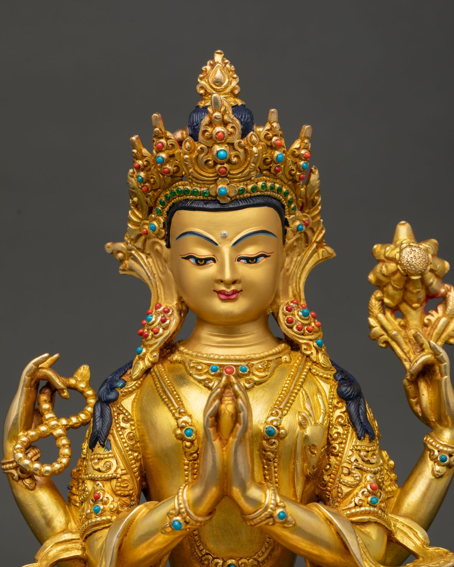 handcrafted chenrezig statue showing intricate copper and gold craftsmanship close up
