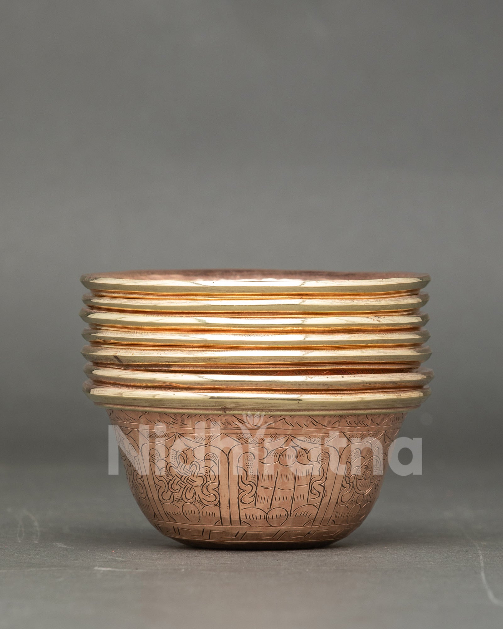Handcrafted copper water offering bowls decorated with sacred Buddhist symbols