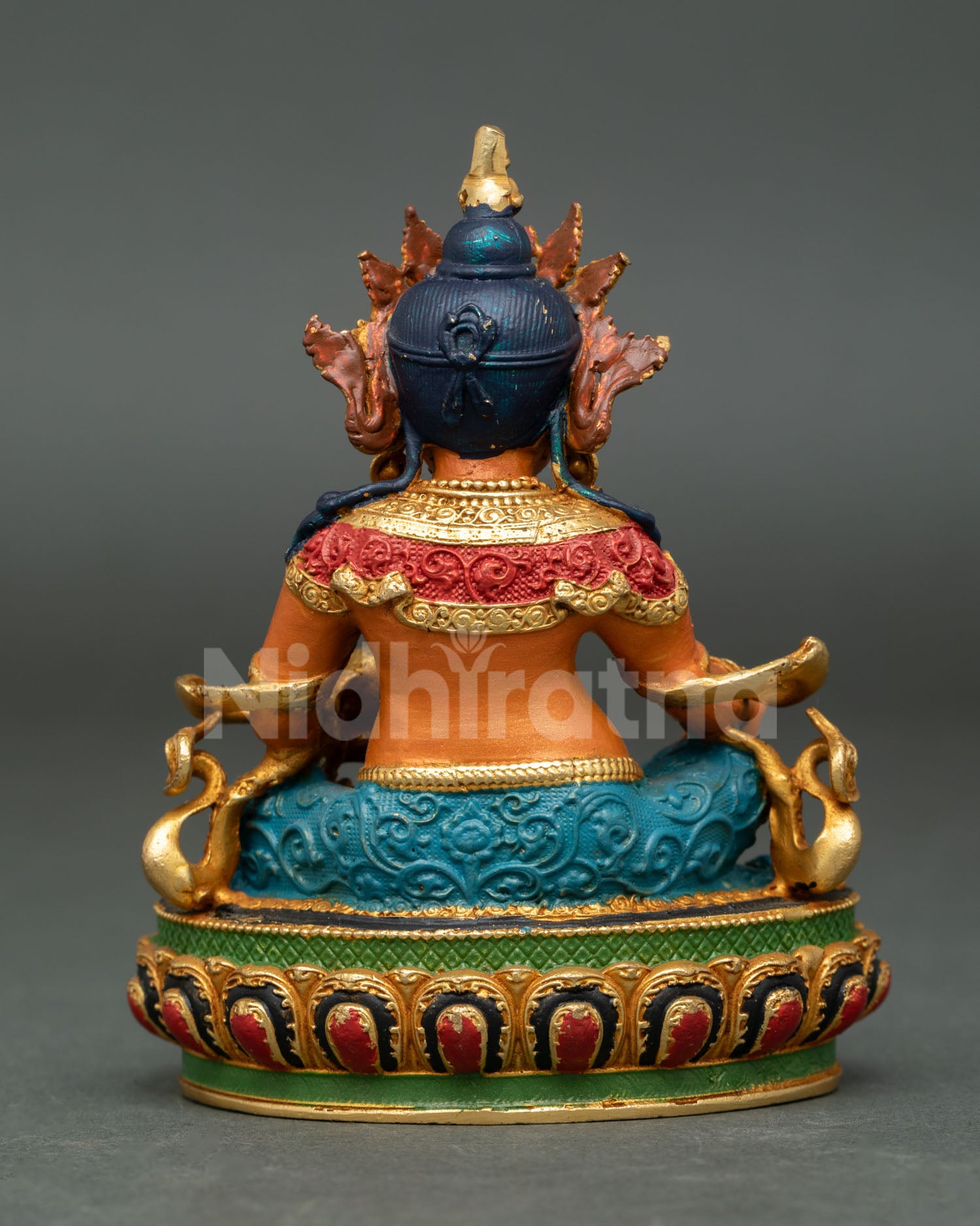 Handcrafted Dzambhala Statue from Patan Nepal with copper body gold gilded details and colorful painted accents.