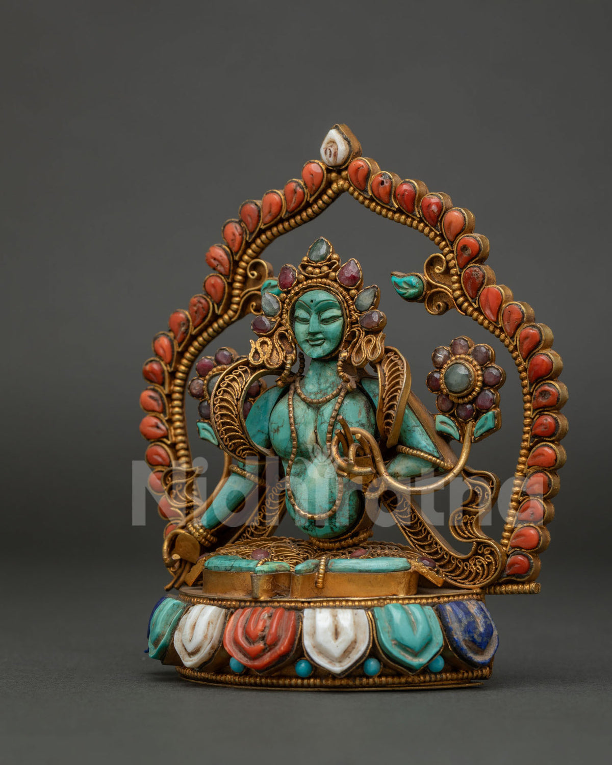 handcrafted goddess green tara statue seated on precious stone lotus seat side view