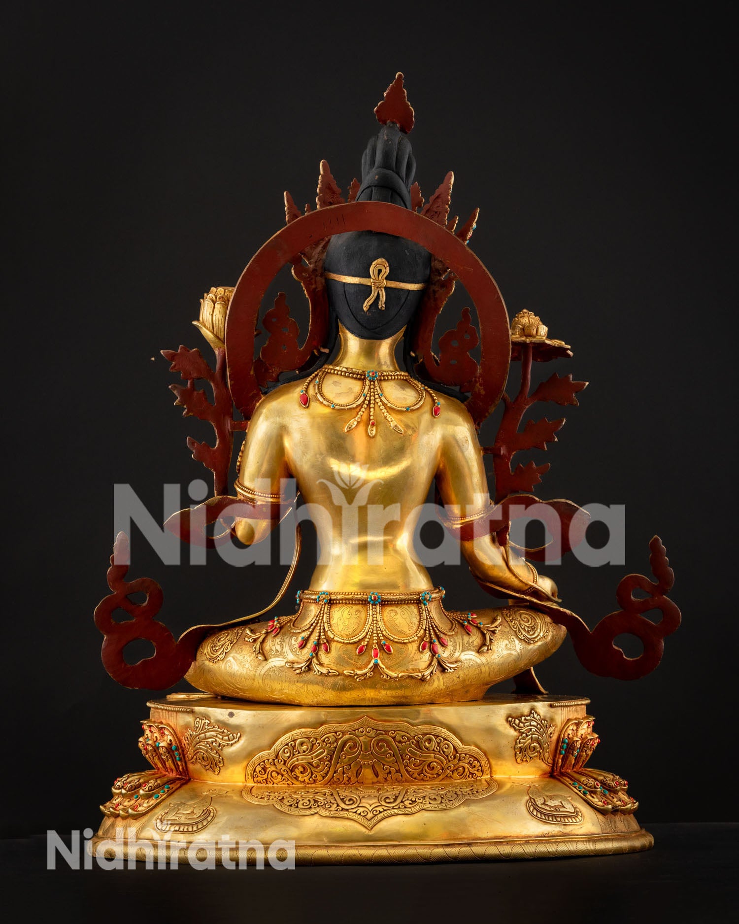 Handcrafted Green Tara statue displaying detailed metal craftsmanship polished copper surface and sacred Himalayan artistry