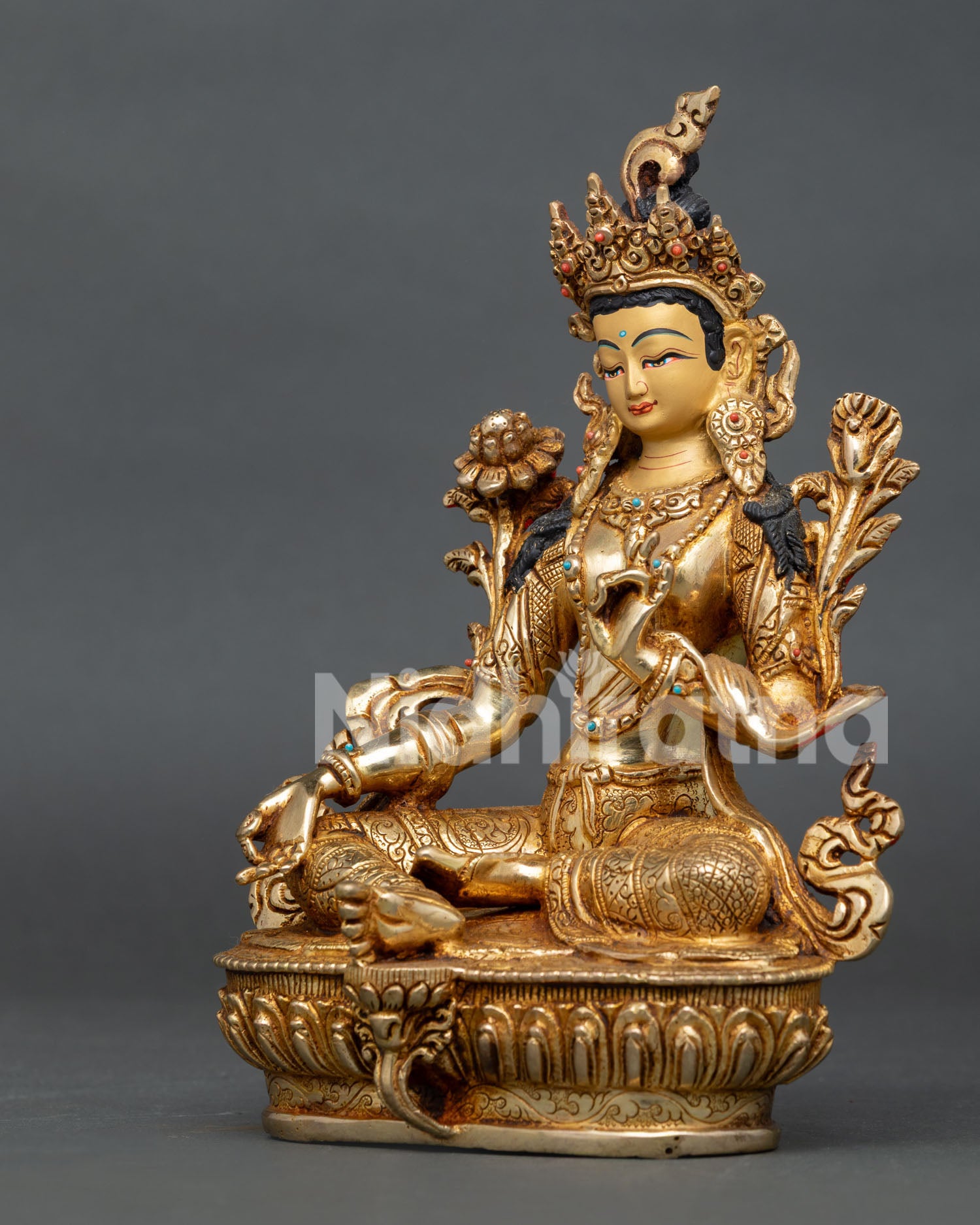 Handcrafted Green Tara Statue in gold gilded copper with semi precious stones from Nepal.