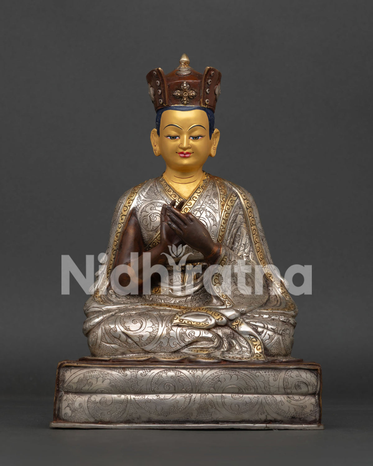 Handcrafted Karmapa statue from Patan Nepal with floral motif robe and devotional gesture.