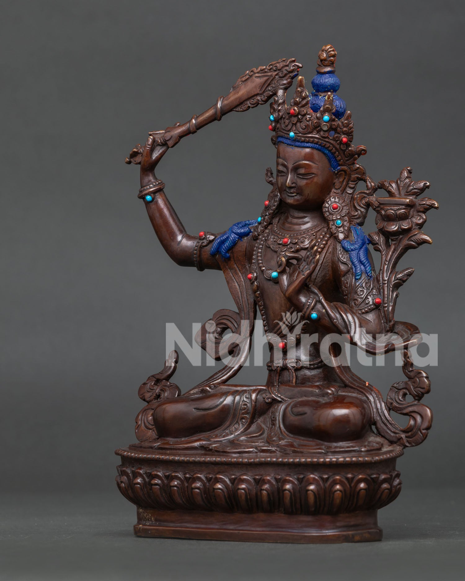 Handcrafted Manjushri statue featuring oxidized copper, traditional lost wax casting, turquoise and coral stones