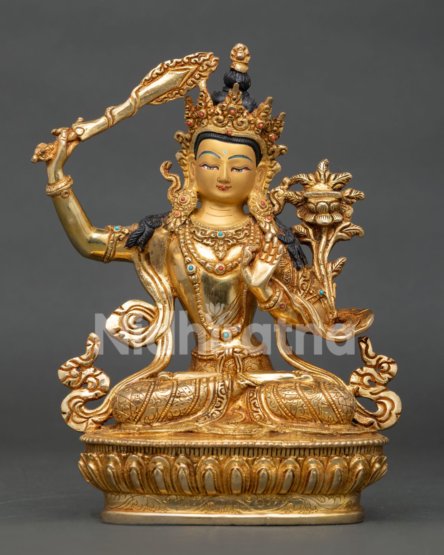 Handcrafted manjushri statue with gold gilded copper body and gold painted face.