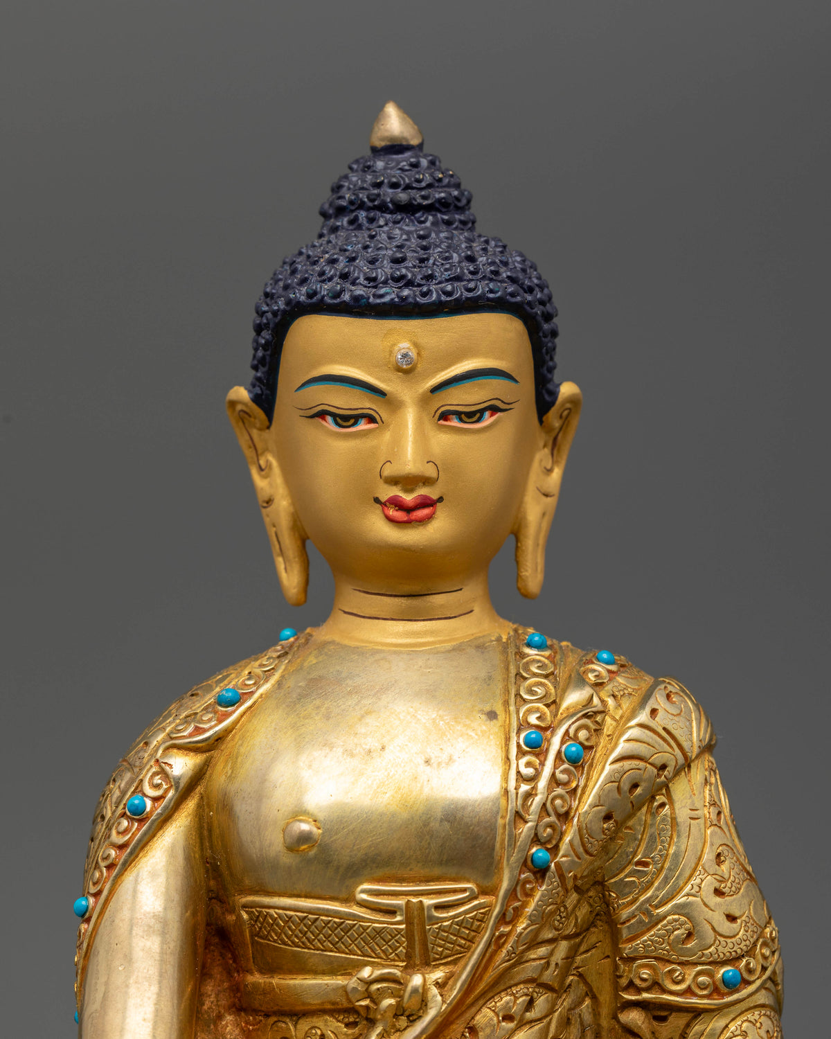 Handcrafted Nepalese Buddhist statue with gold painted face