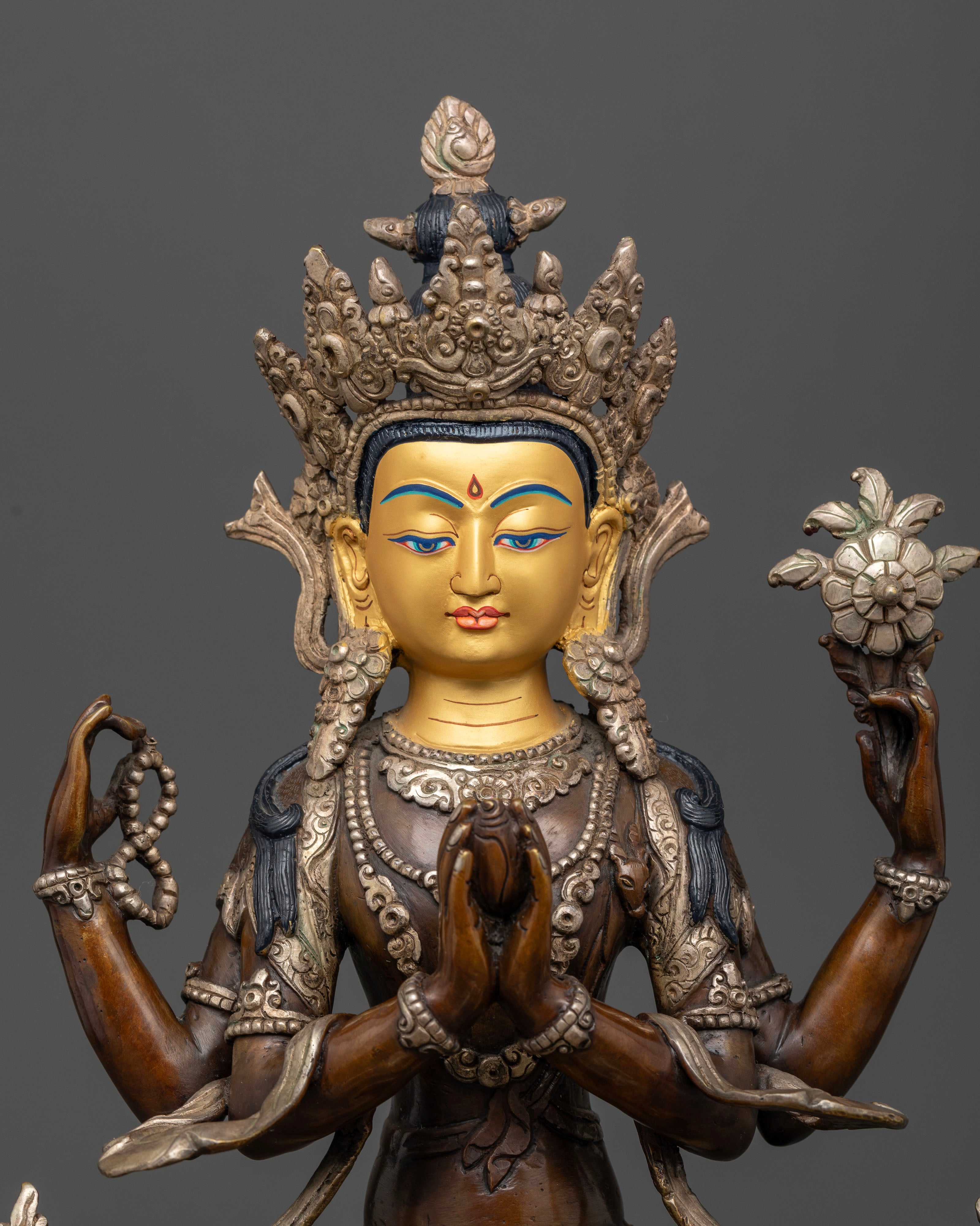 Handcrafted Nepalese Four Armed Chenrezig sculpture with gold-painted face and ornate details