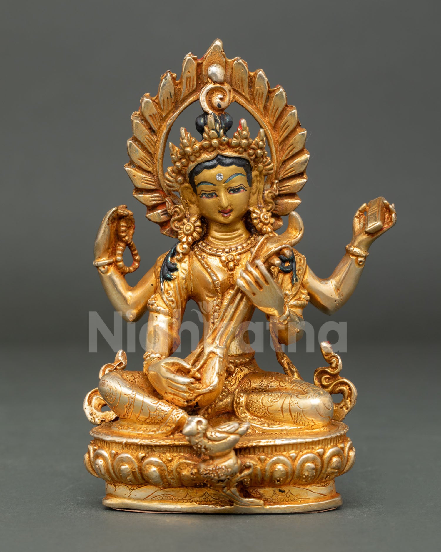 Handcrafted Saraswati Statue from Patan Nepal with gold gilded copper body and gold painted face.