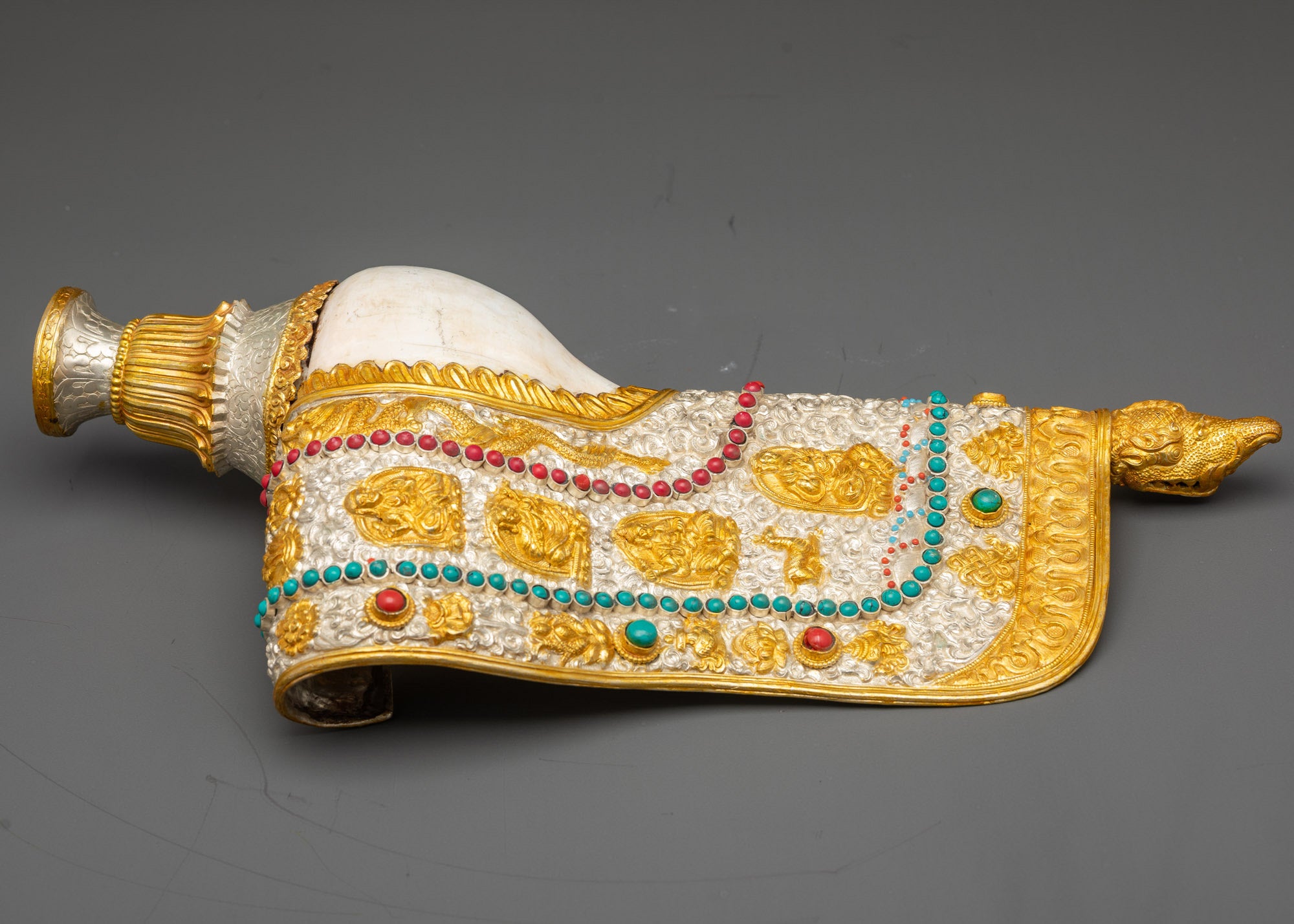 handcrafted Himalayan conch shell depicting Buddhist masters and auspicious symbols