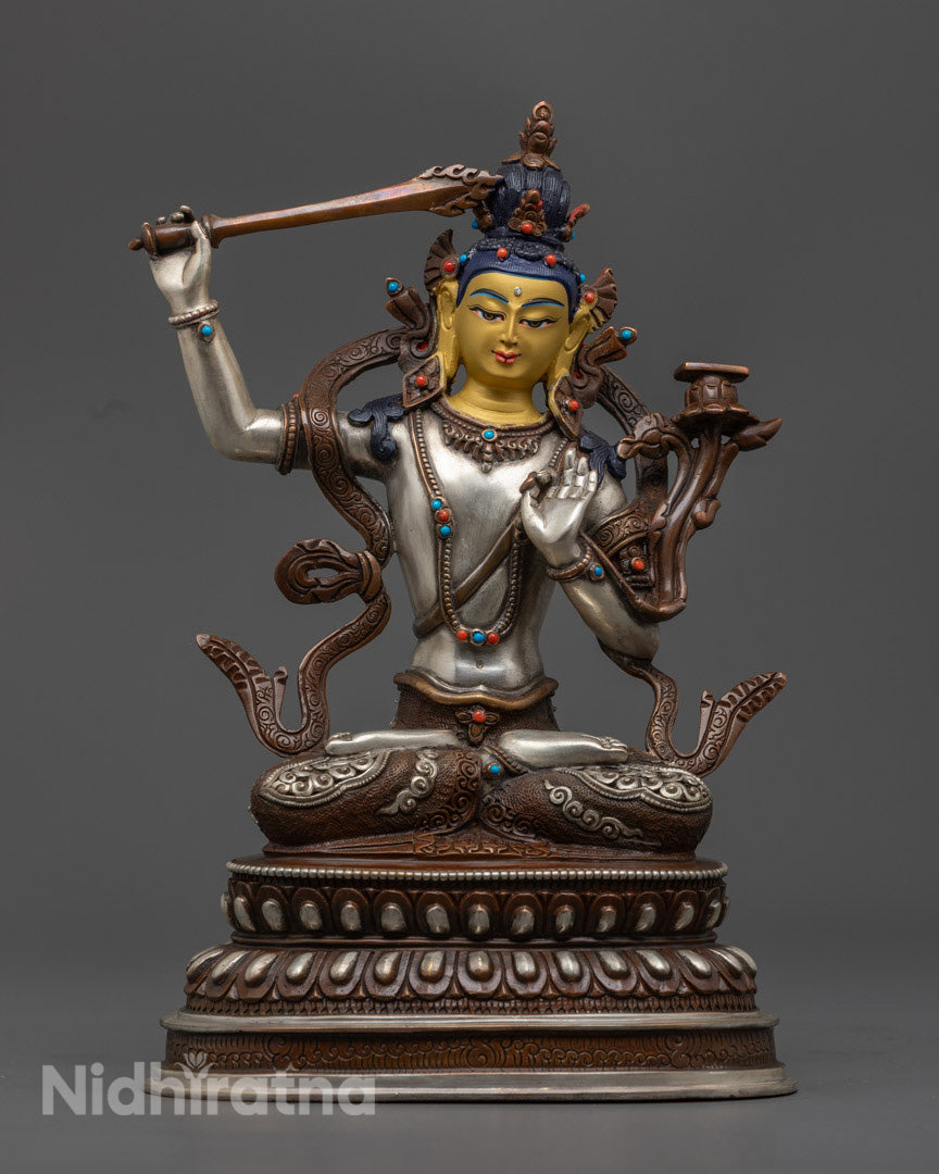 handcrafted Manjushri statue made from oxidized copper with silver plating and inlaid semi-precious stones, seated in meditation posture