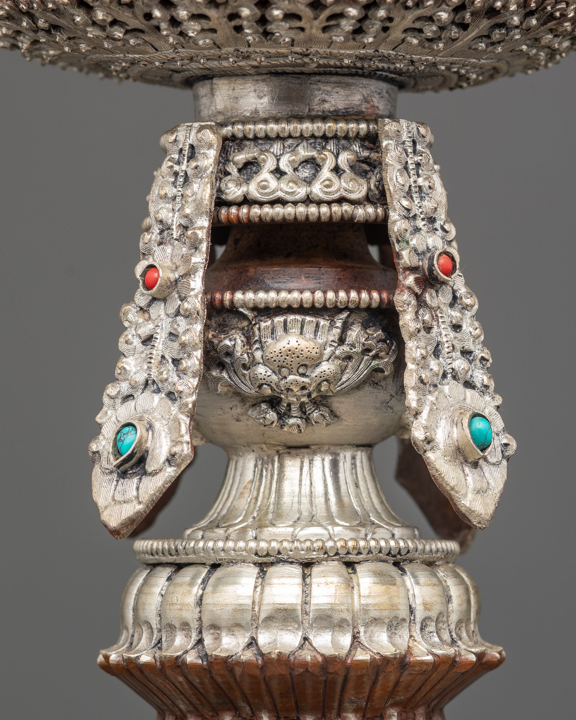 handmade Himalayan Butter Lamp with tall, ornate silver stem and sacred design