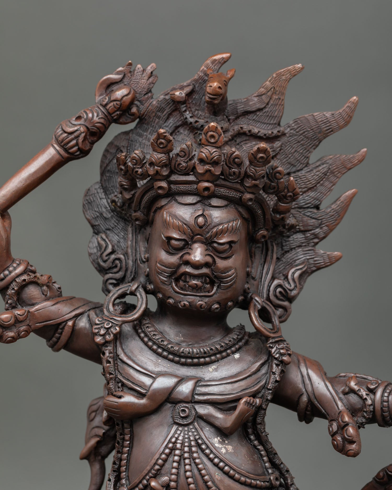 Hayagriva close up fierce face enlightened protector deity oxidized copper Buddhist statue detailed Himalayan craft