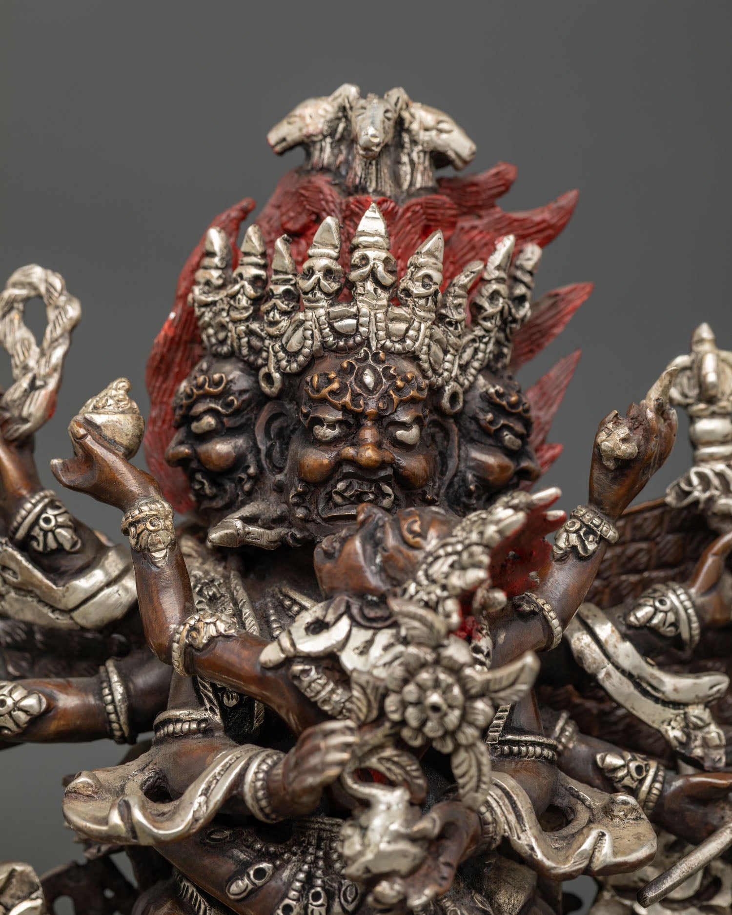 Hayagriva statue close-up, oxidized copper, silver-plated details, lotus seat, Nepalese metalwork