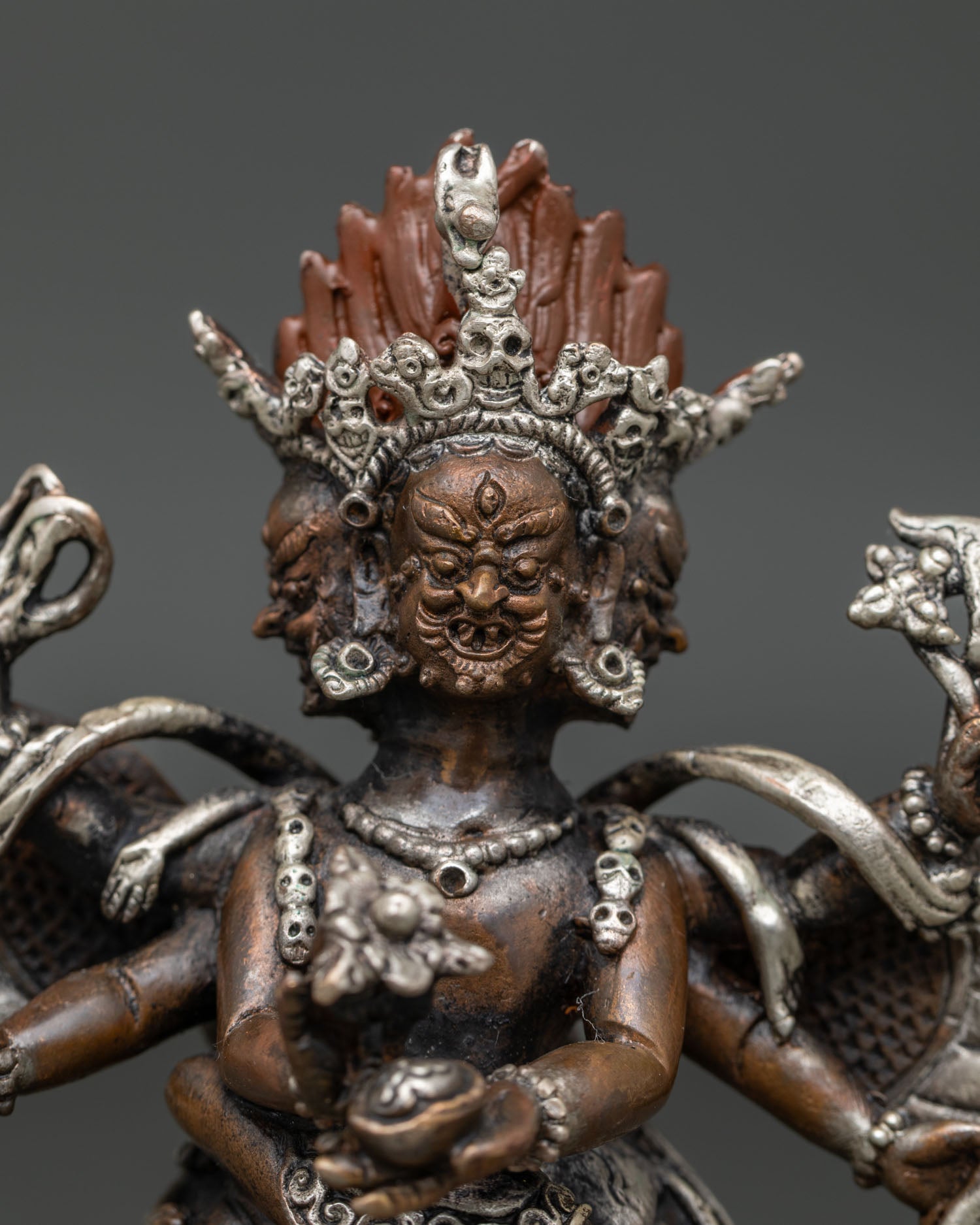 Hayagriva statue holding kapala kartika knife and sacred ritual implements.