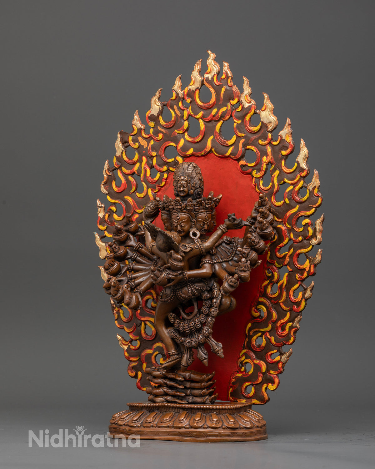 Hevajra and nairatmya statue standing on lotus pedestal with flaming halo.