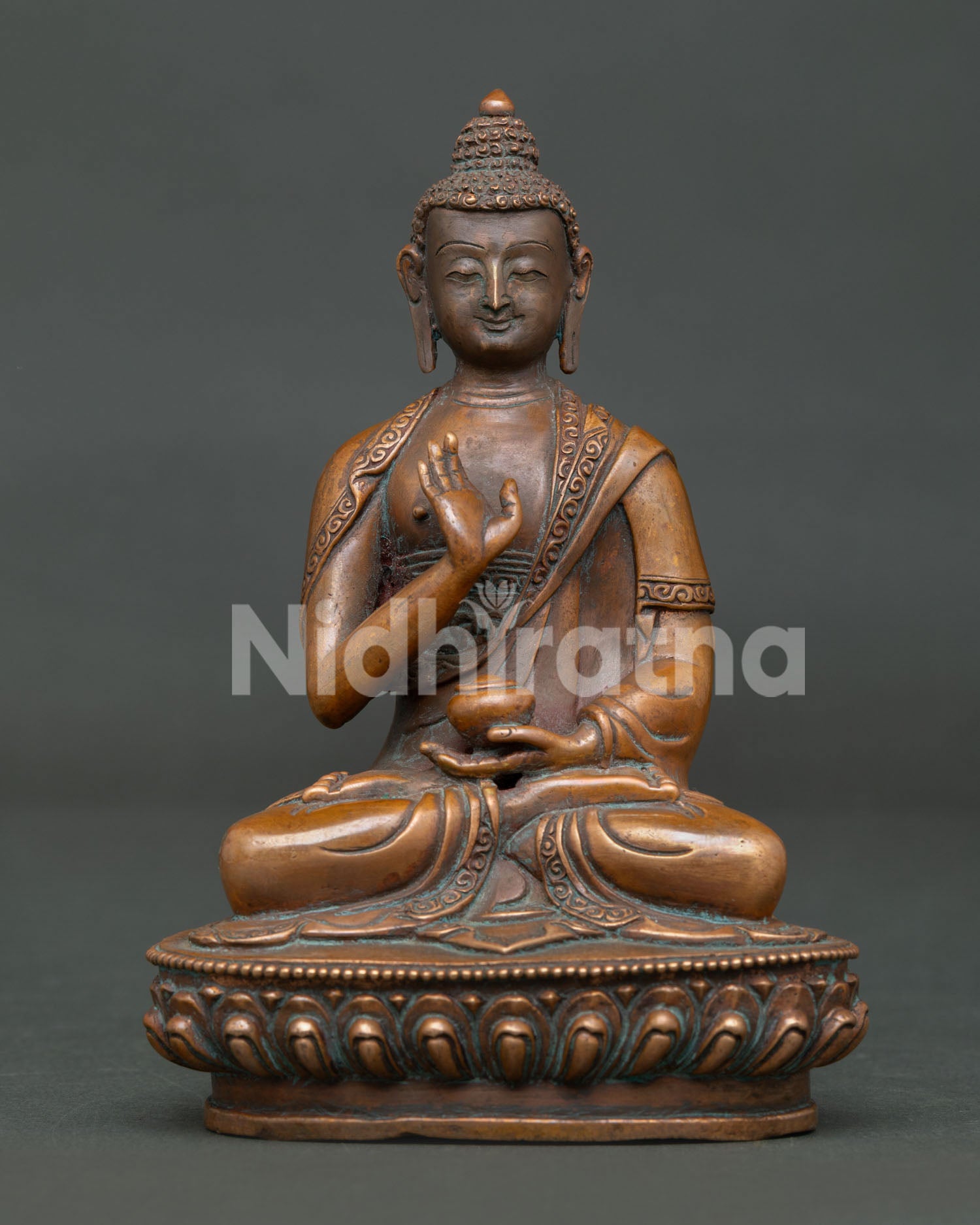 Himalayan Amoghasiddhi Buddha statue with oxidized copper finish and lotus base.